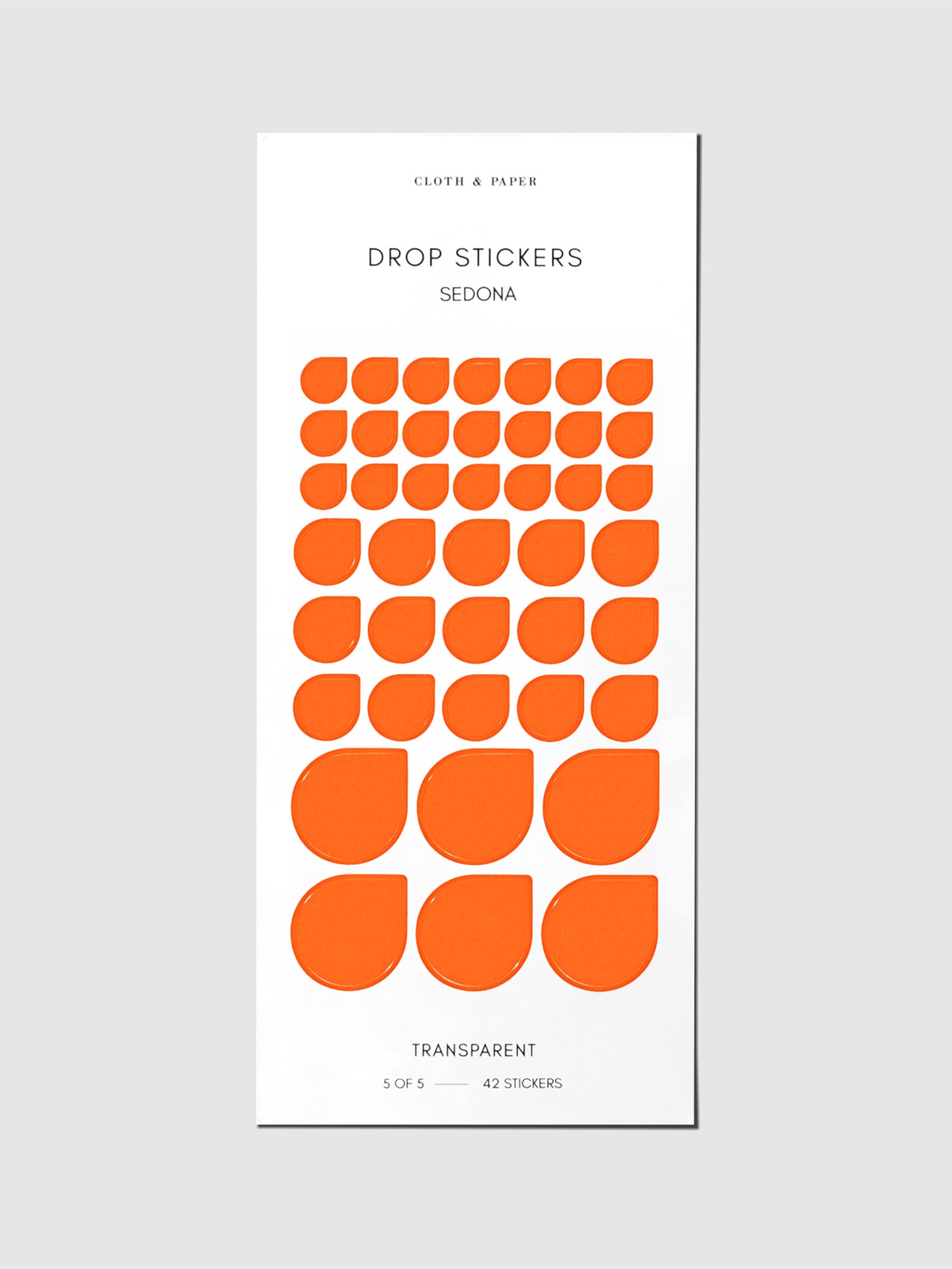 Minimal Shape Sticker Set, Transparent Drops, Sedona, Cloth and Paper. Drop stickers in their packaging on a gray background.