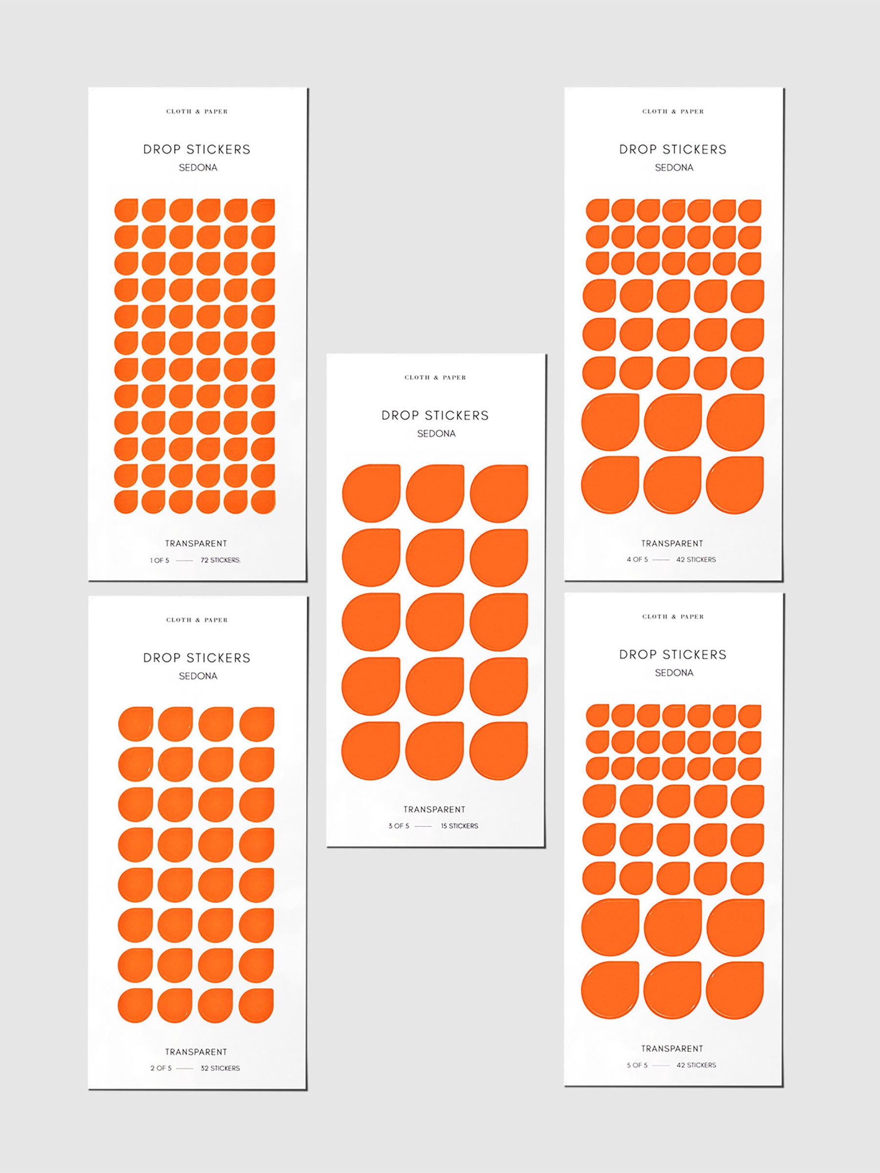 Minimal Shape Sticker Set, Transparent Drops, Sedona, Cloth and Paper. Drop stickers in their packaging on a gray background.