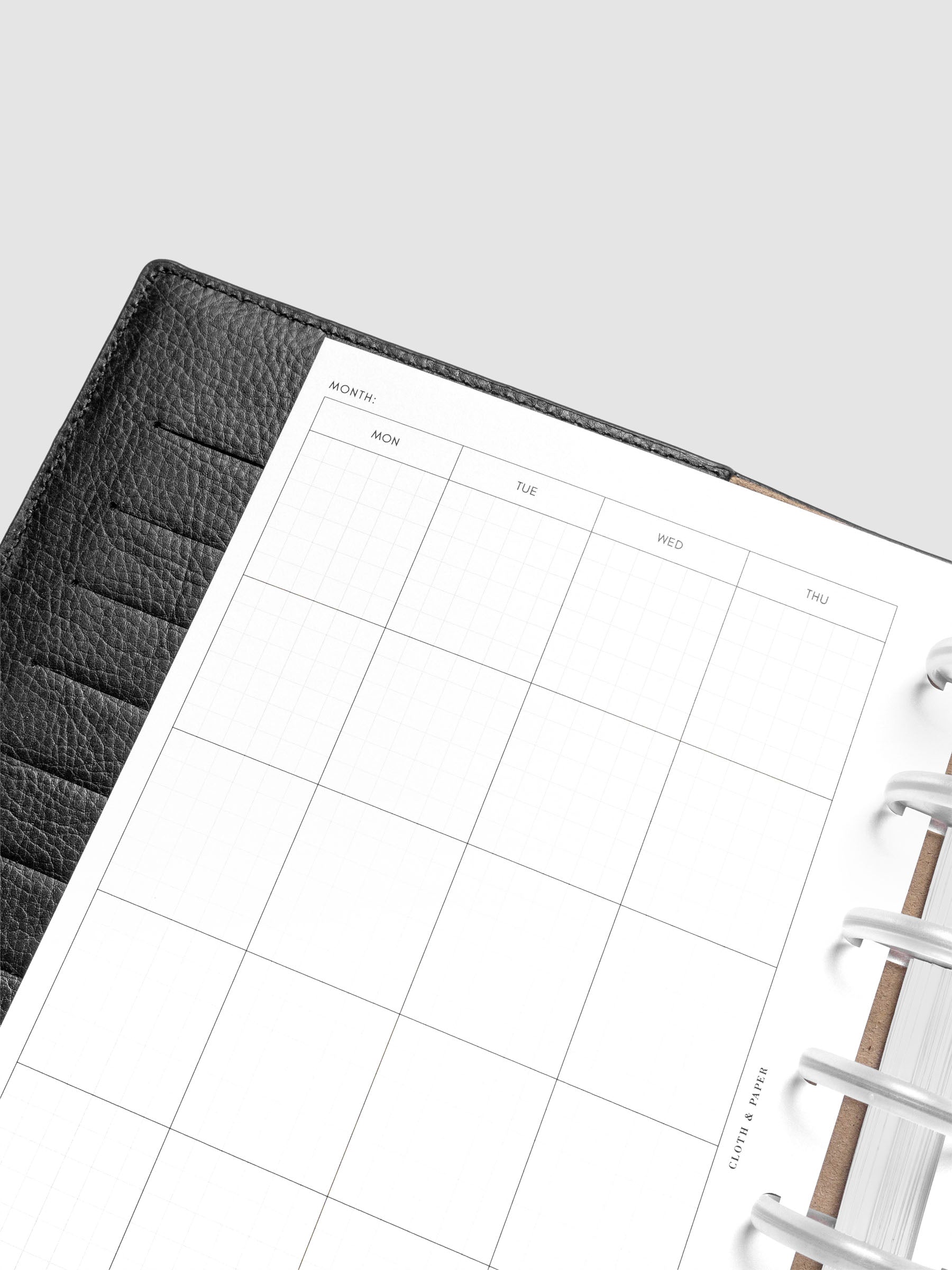Close up of the Monthly Graph Planner Inserts showing a calendar view of the month with graph note style interior.