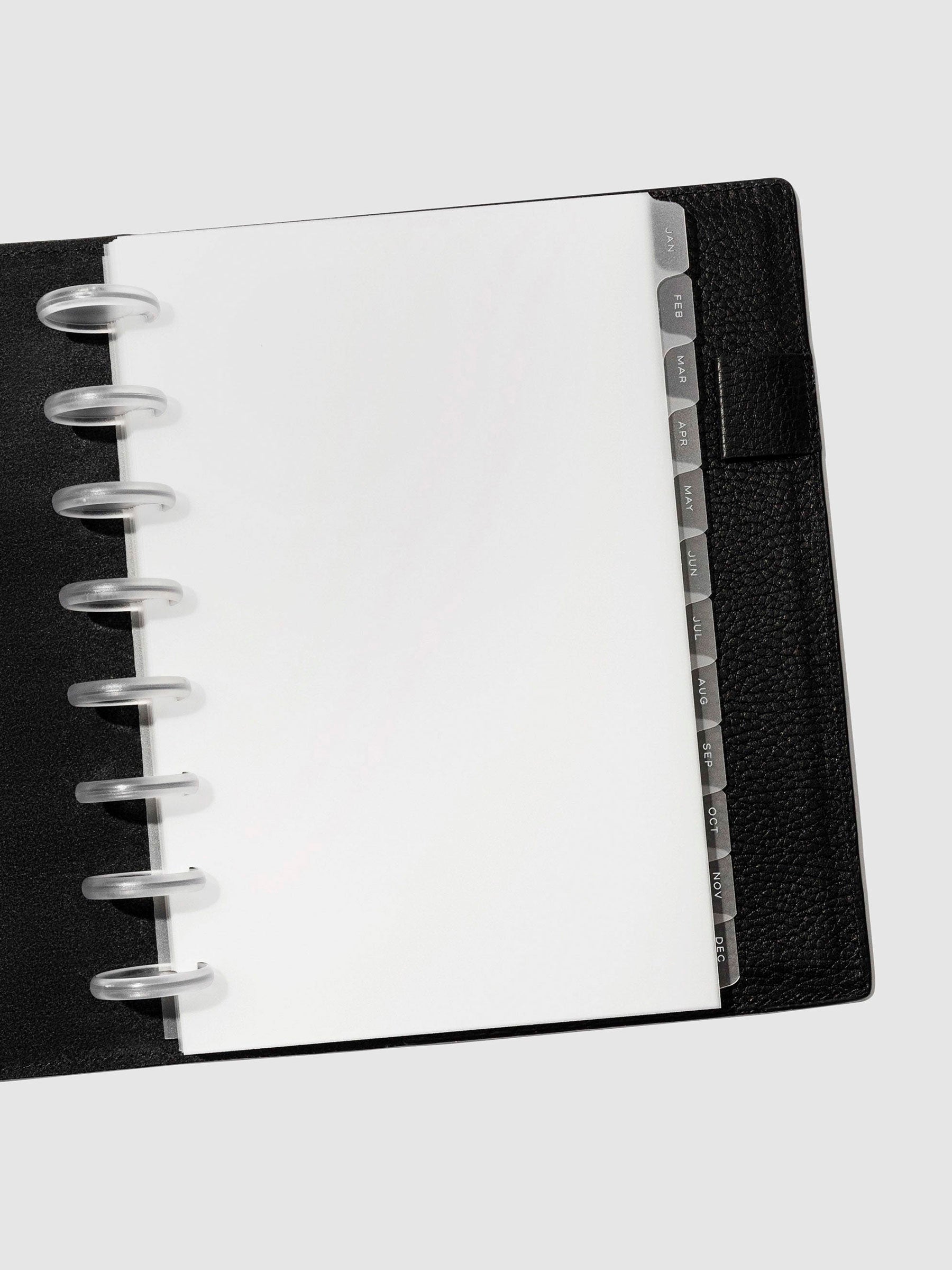 White foil tabs displayed in use inside a black leather folio.