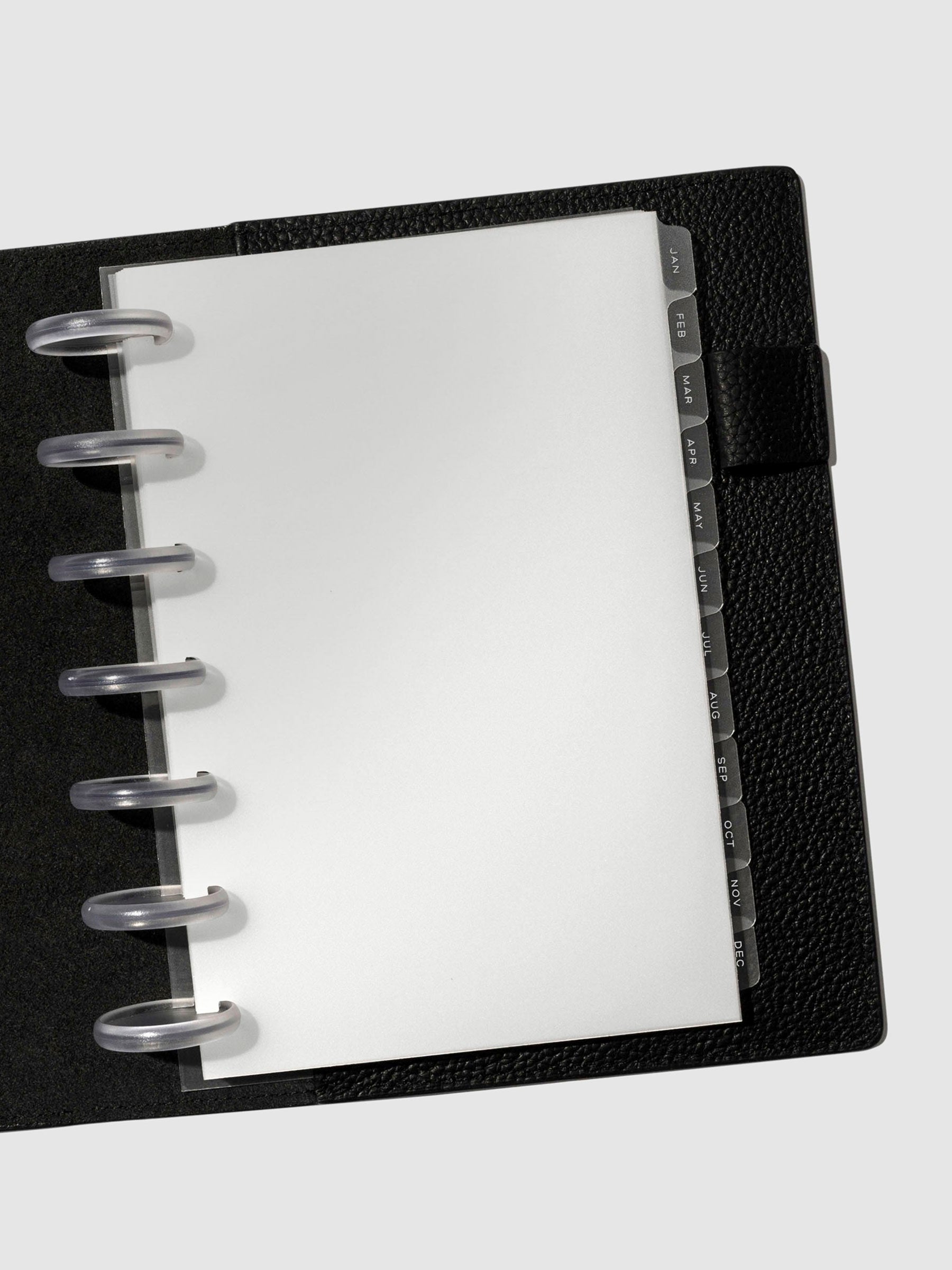 White foil tabs displayed in use inside a black leather folio.