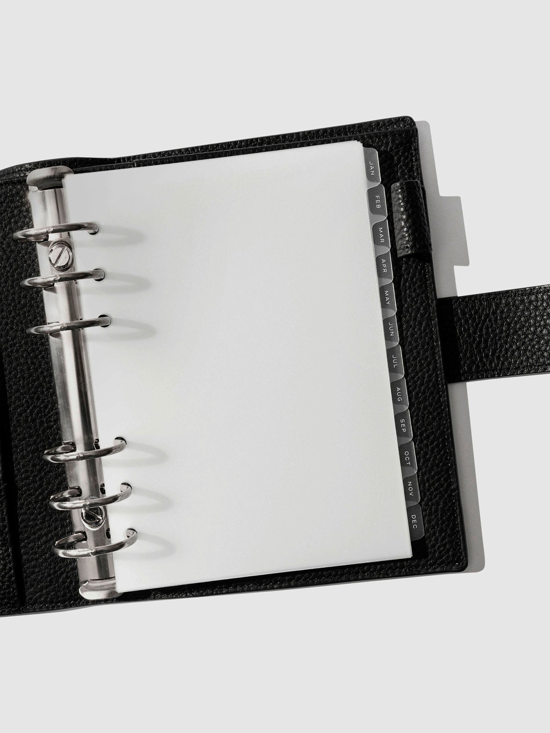 White foil tabs displayed in use inside a black leather folio.