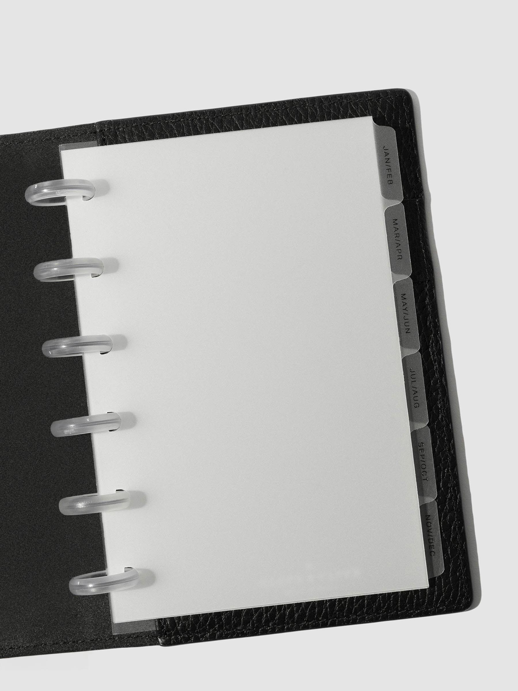 Black foil tabs displayed in use inside a black leather folio.