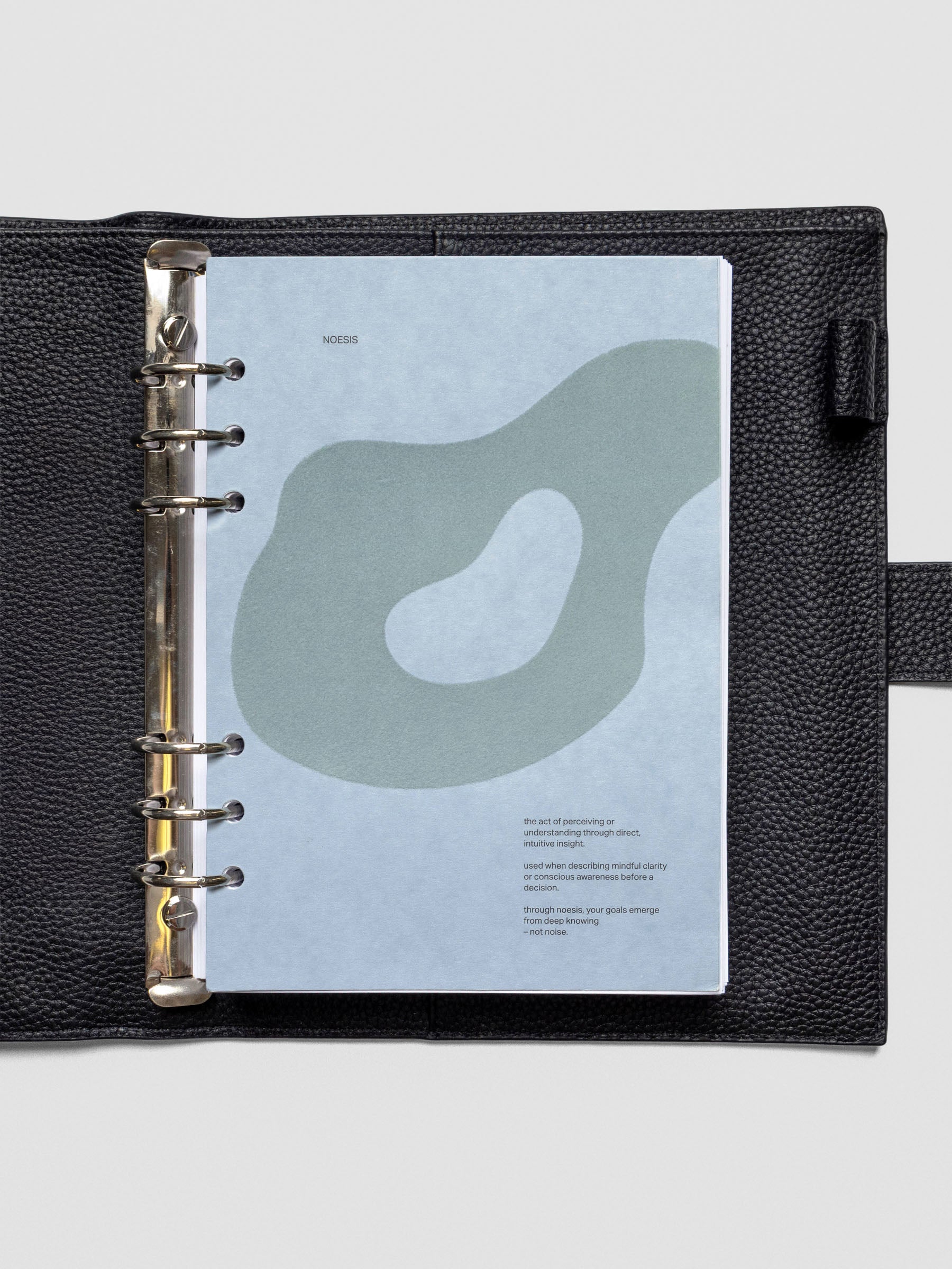 Textured blue planner dashboard with organic shape design flocked in blue-green with text shown in A5 size inside a leather planner cover.