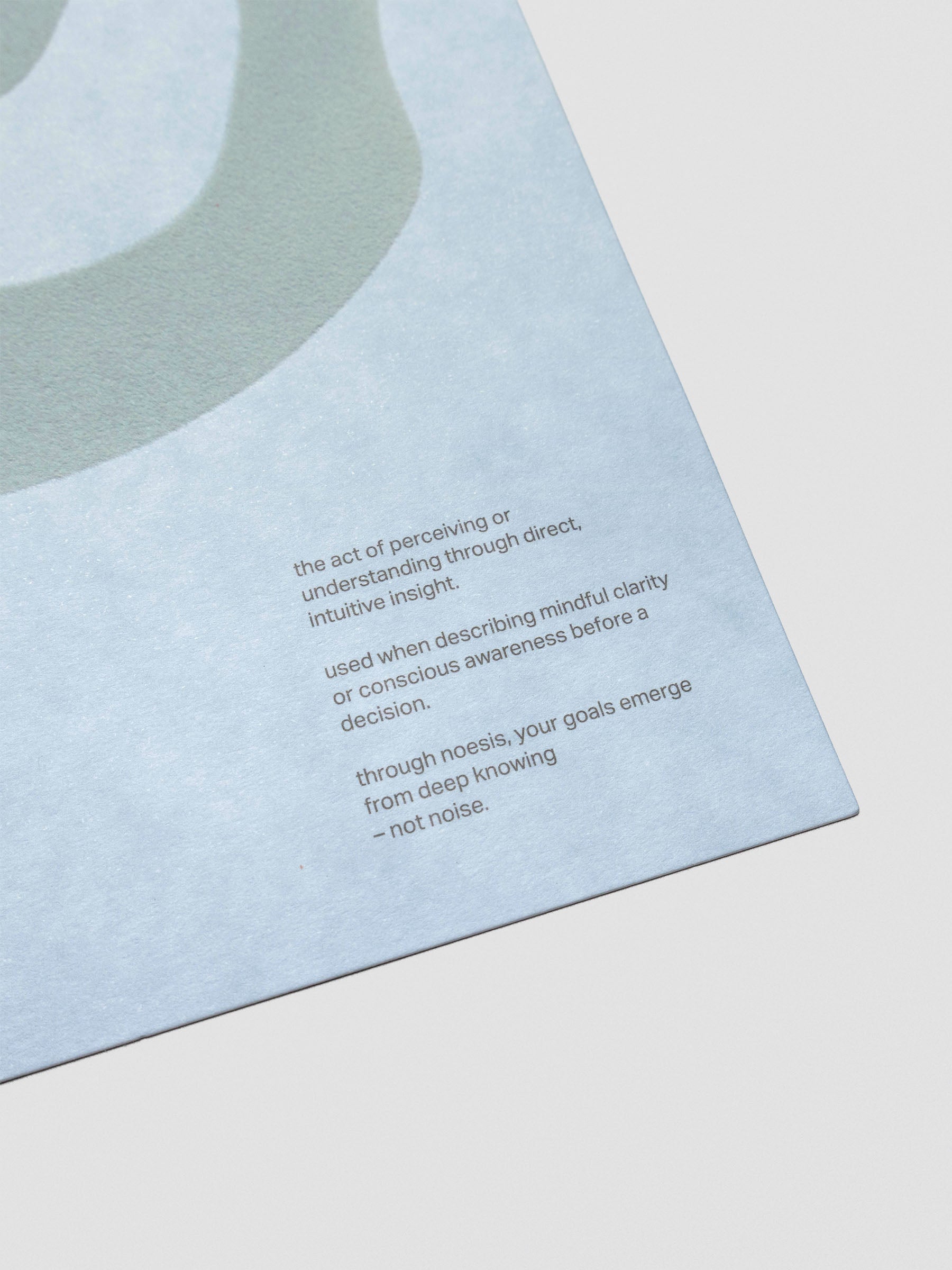 Close up of a blue planner dashboard with text reading "the act of perceiving or understanding through direct, intuitive insight. used when describing mindful clarity or conscious awareness before a decision. through noesis, your goals emerge from deep knowing - not noise."