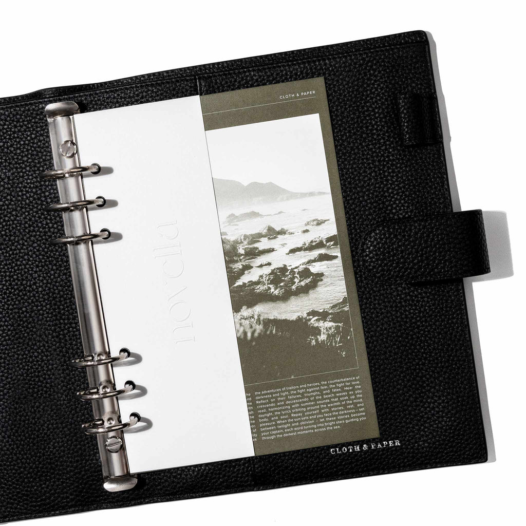 Novella Dashboard Duo displayed inside a black leather planner. Size shown is A5.