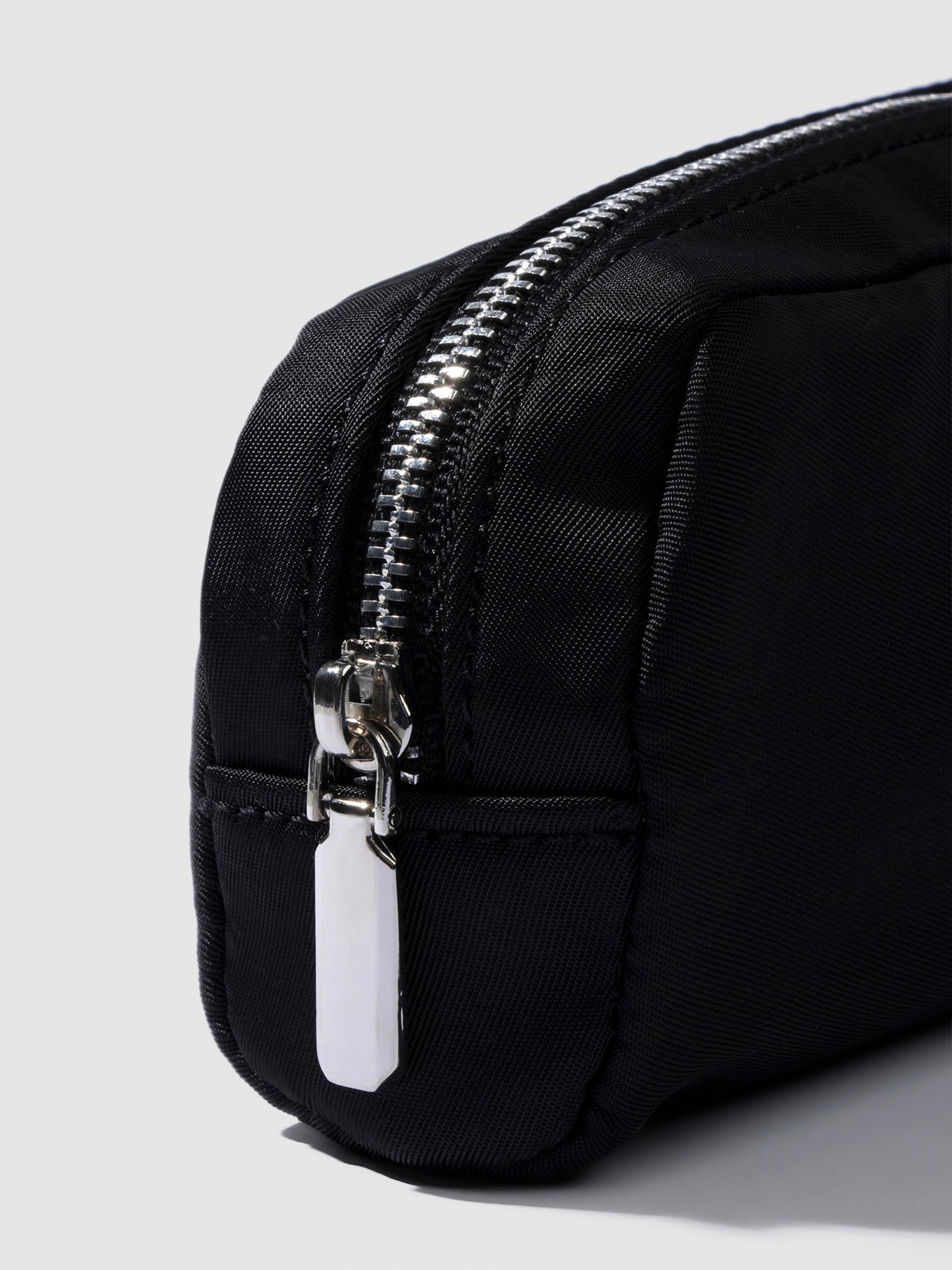 Closeup of pencil pouch's zipper. Color featured is black.