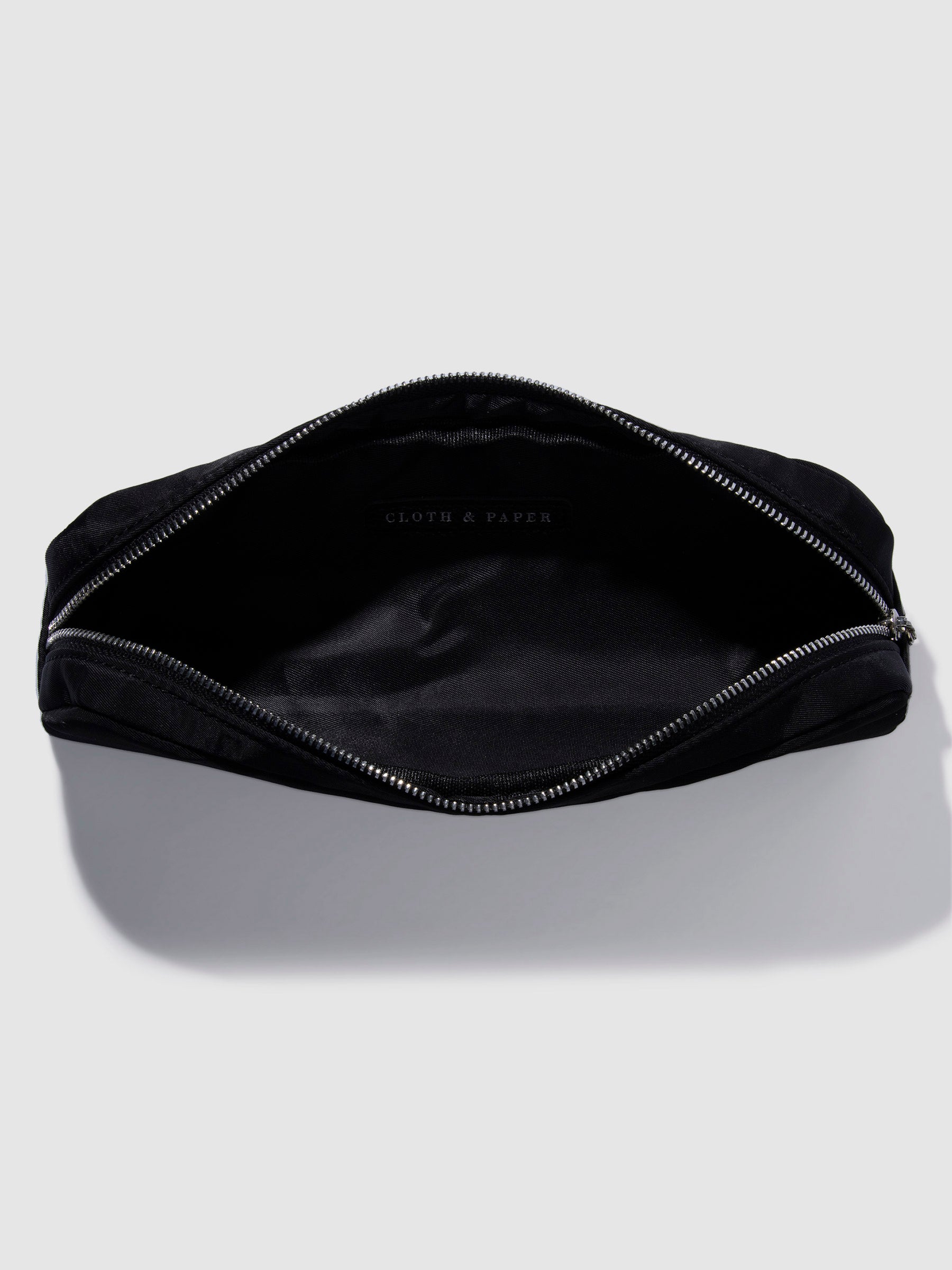 Pencil pouch displayed unzipped on a neutral background. Color featured is black.