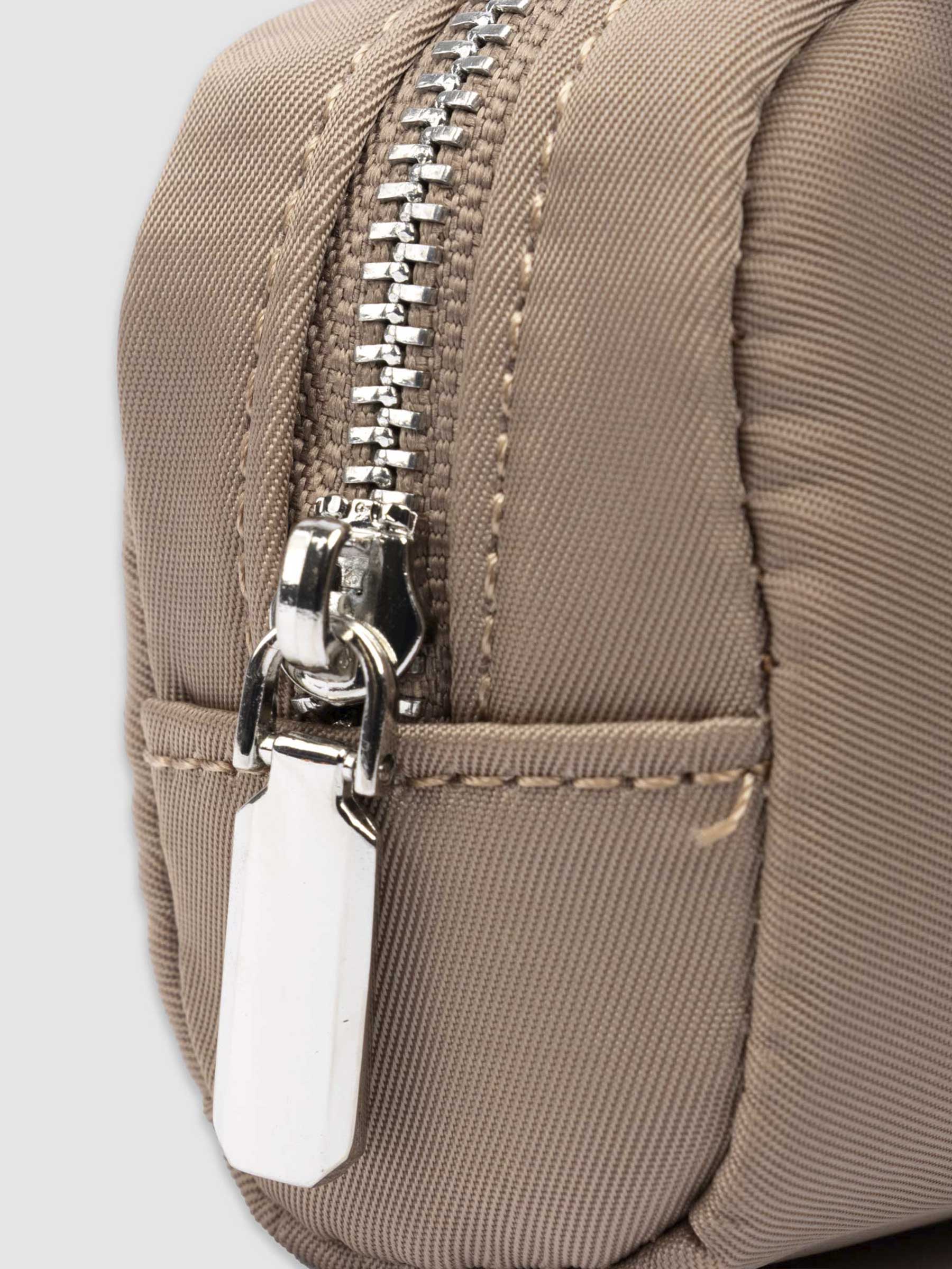 Closeup of pencil pouch's zipper. Color featured is fossil.