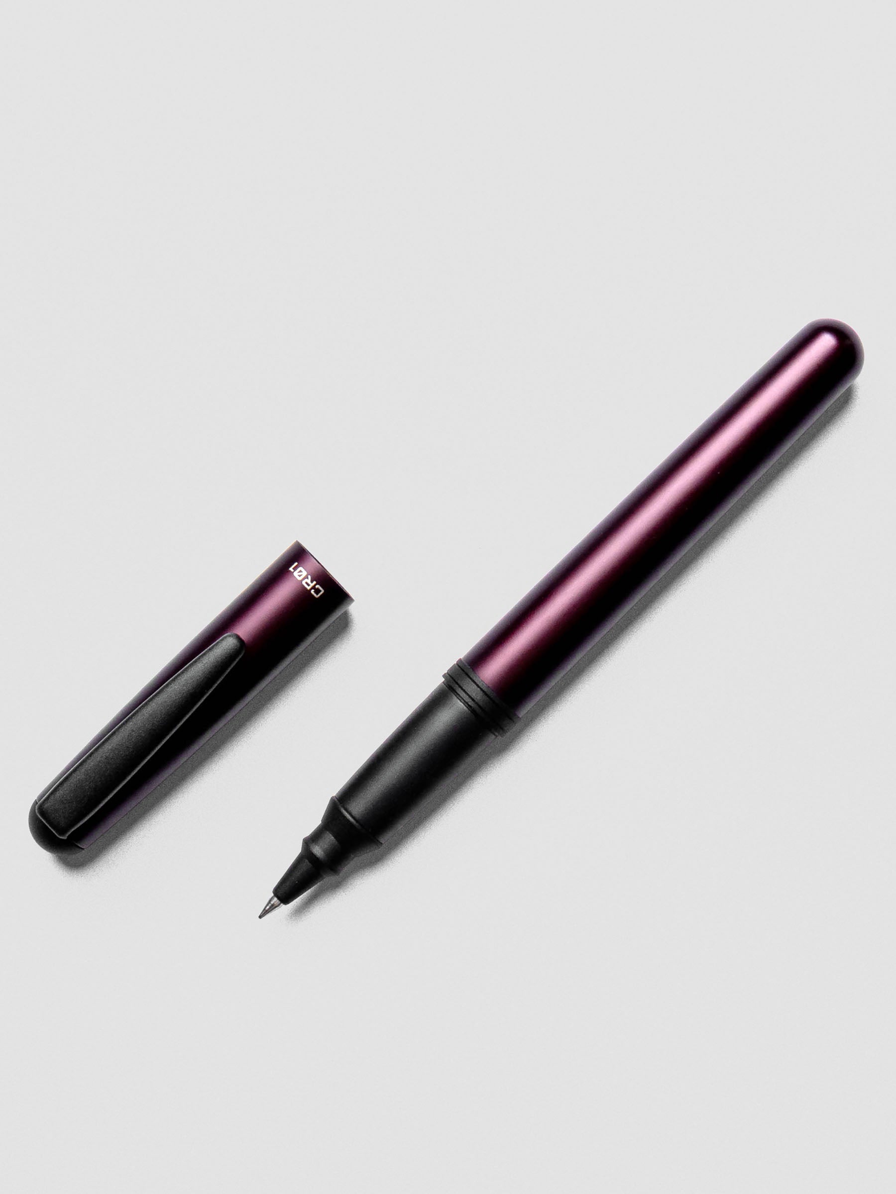 OHTO CR01 Ceramic Rollerball Pen in 0.5 mm nib in the color Matte Wine shown with the pen cap off beside the pen.