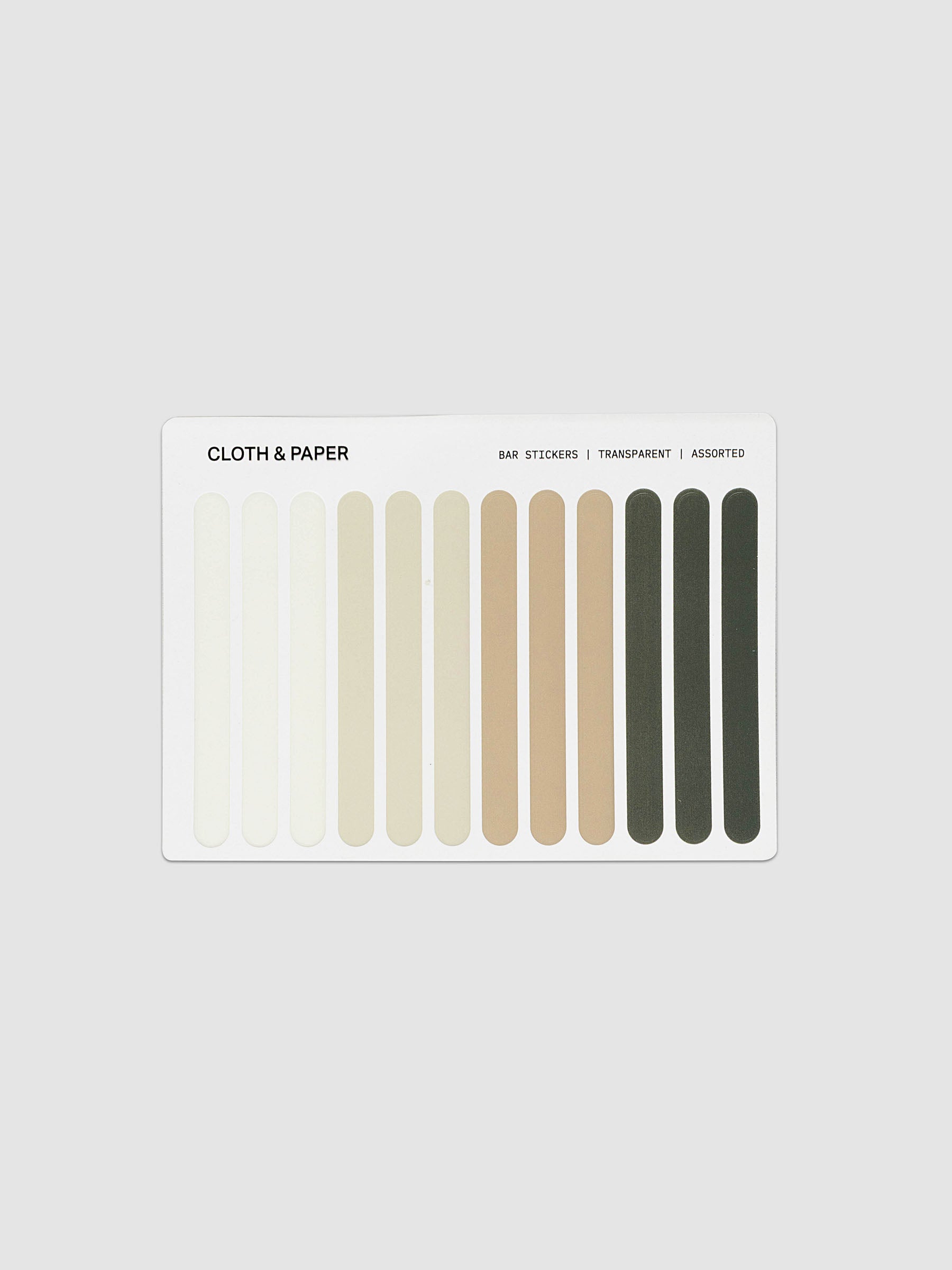 A white rectangular card labeled 'CLOTH & PAPER' with vertical color bars in cream, beige, tan, brown, and dark olive tones on a light gray background.