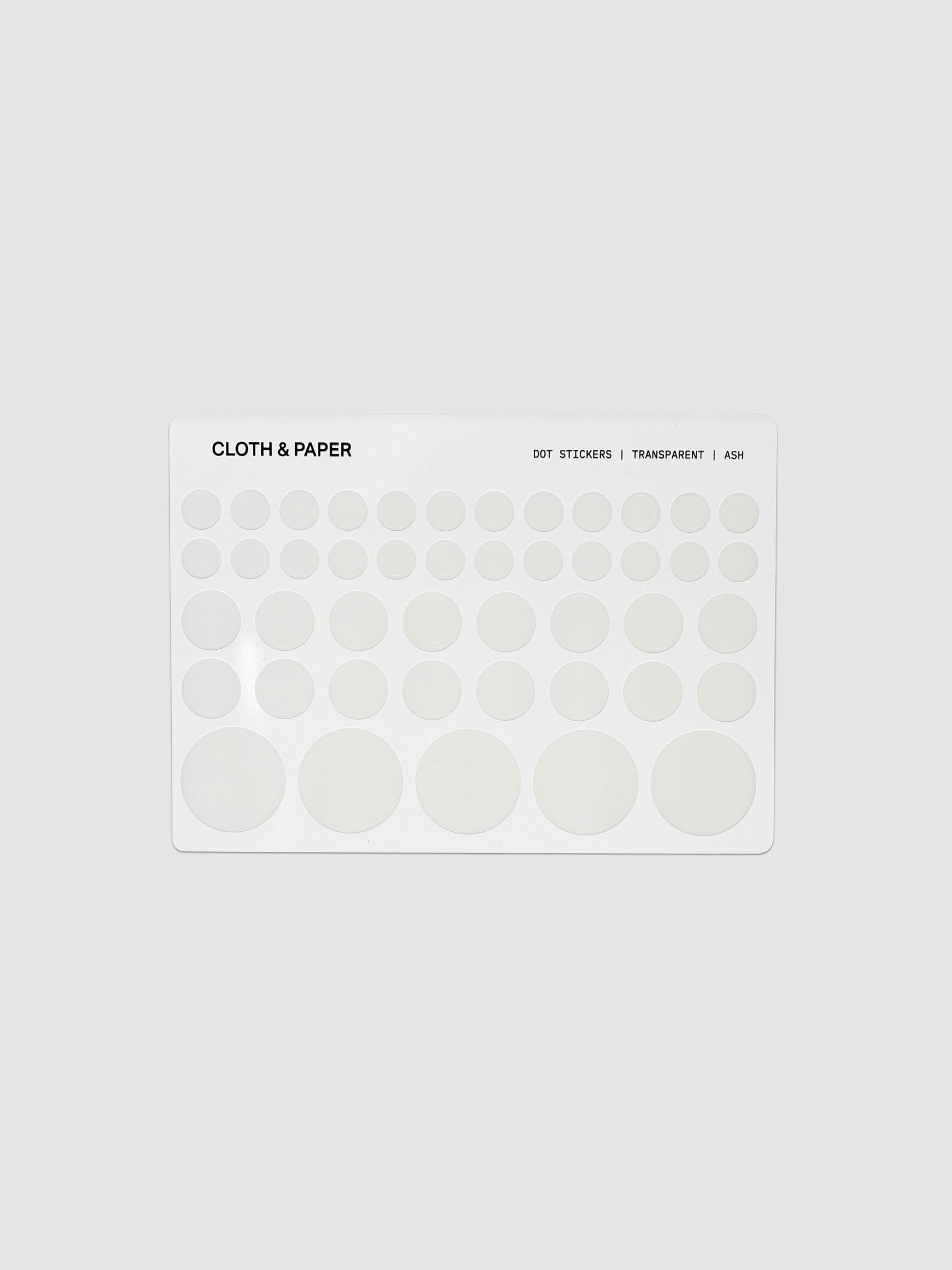 One sheet of transparent dot stickers with letters design in small, medium, and large sizes shown against a neutral background.