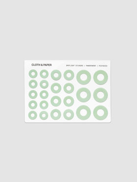 One sheet of circular stickers in varying sizes, featuring a light sage green ring design on a white backing card, set against a solid light gray background.