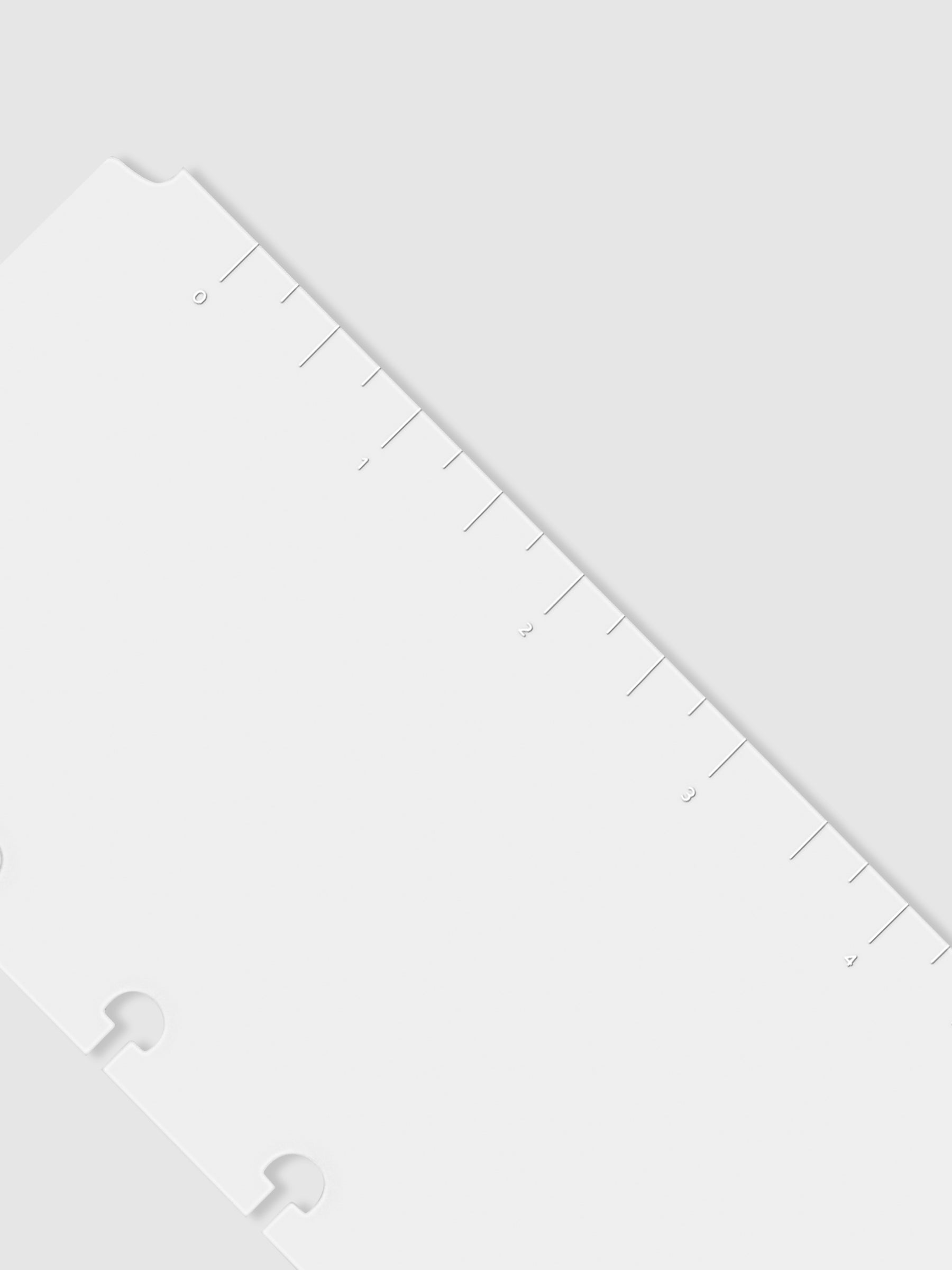 Closeup of page marker displayed on a neutral background. Detail is focused on the white printed ink.