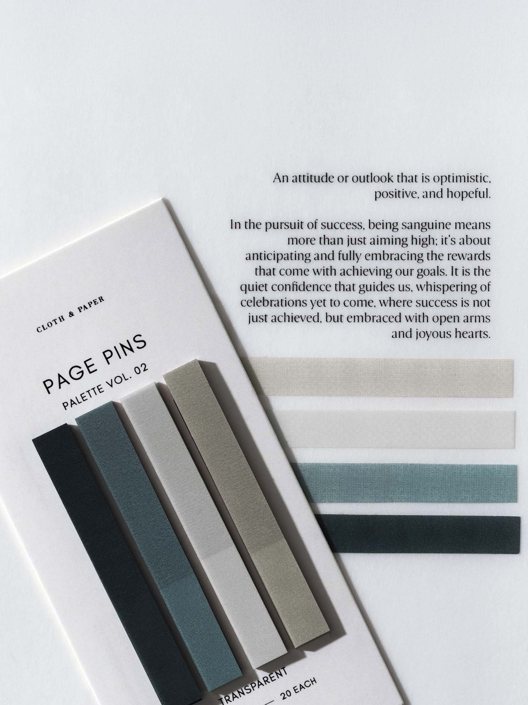 Page Pins Vol 02 on their backing tilted slightly to the left, layered on top of the Sanguine Dashboard quote with one of each of the page pins adhered to the dashboard