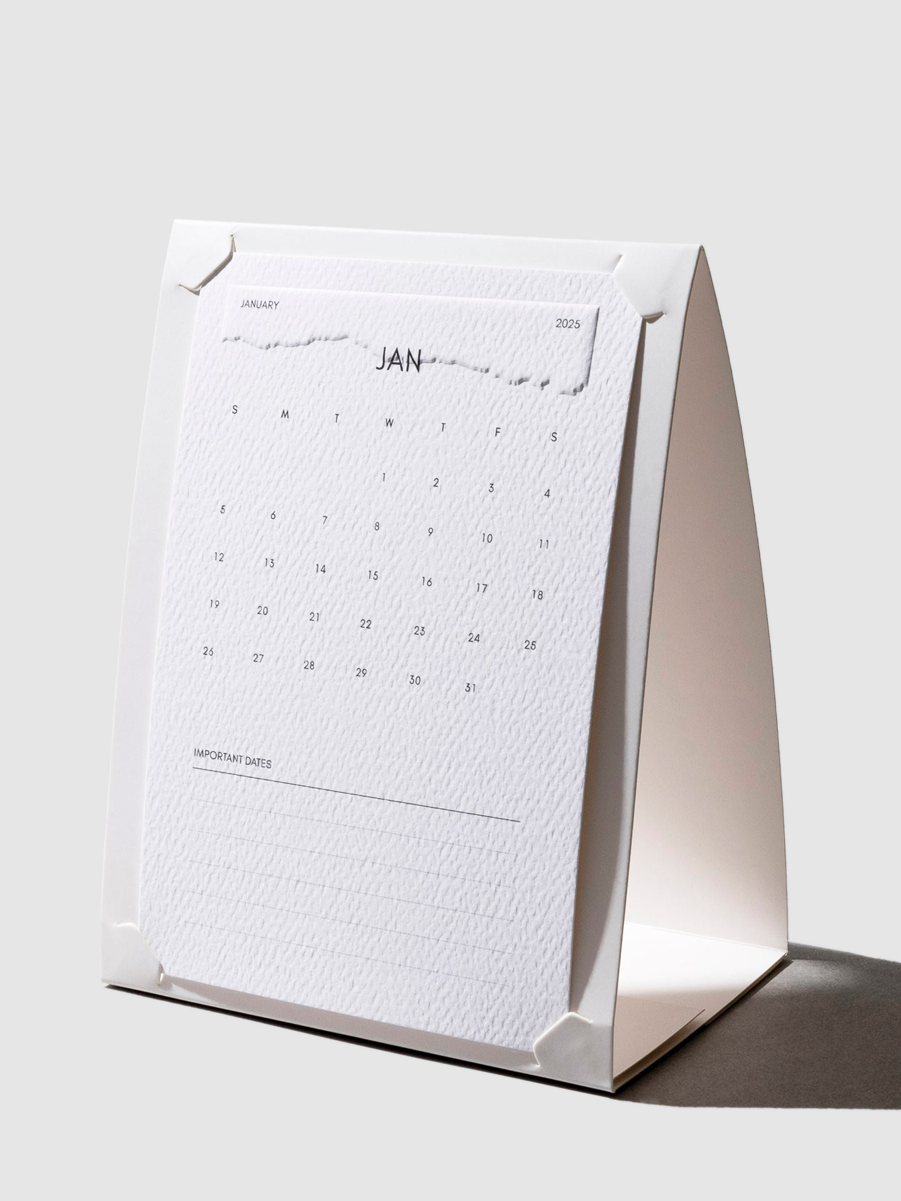 Paper Stand, Cloth and Paper. Stand shown with a 2025 calendar card fit inside of it on a neutral background.