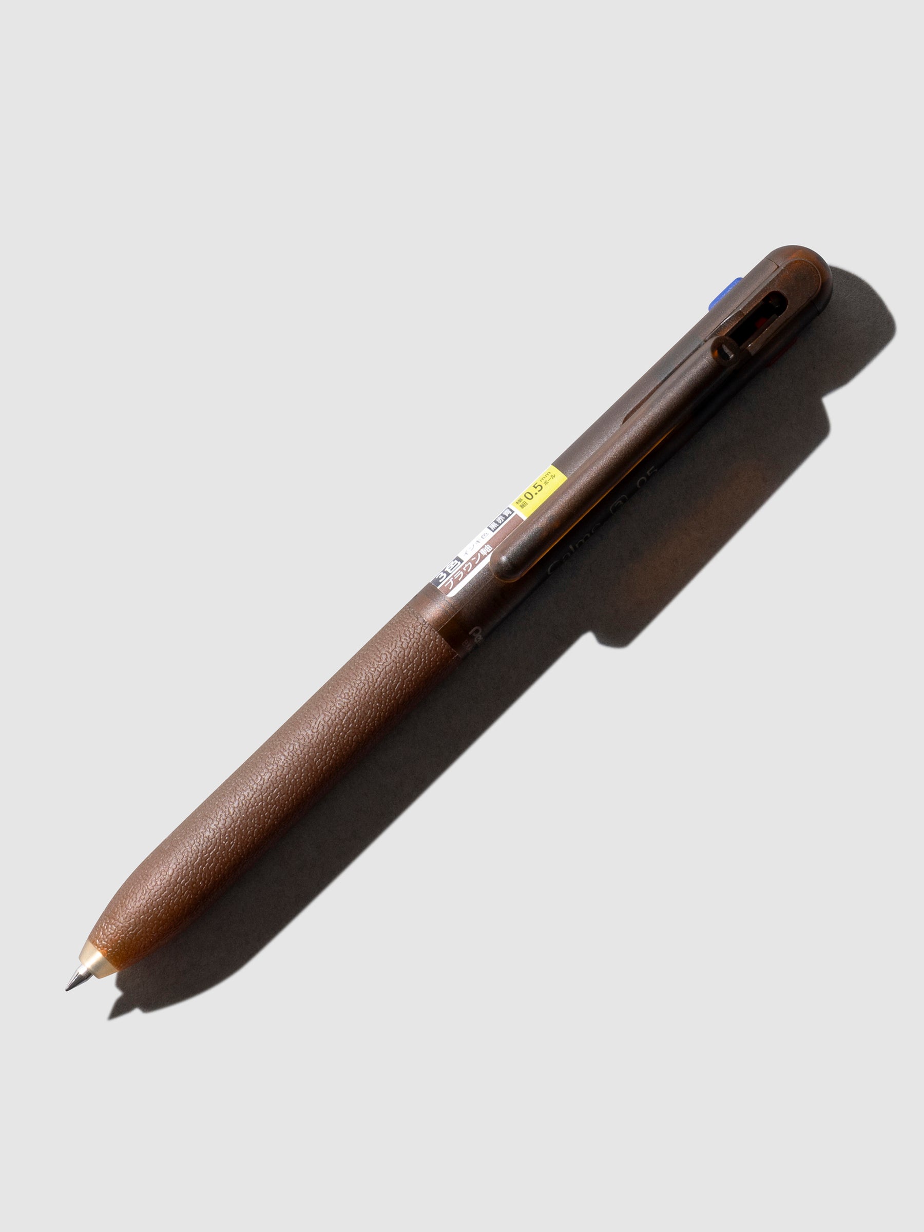 Pentel Calme Pen, Cloth and Paper. Brown pen shown on a neutral background.