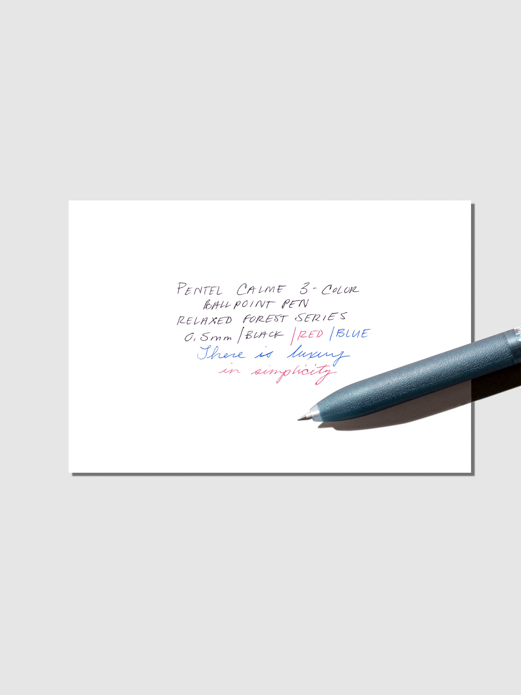 Pen test sheet shown with blue pen on a neutral background.