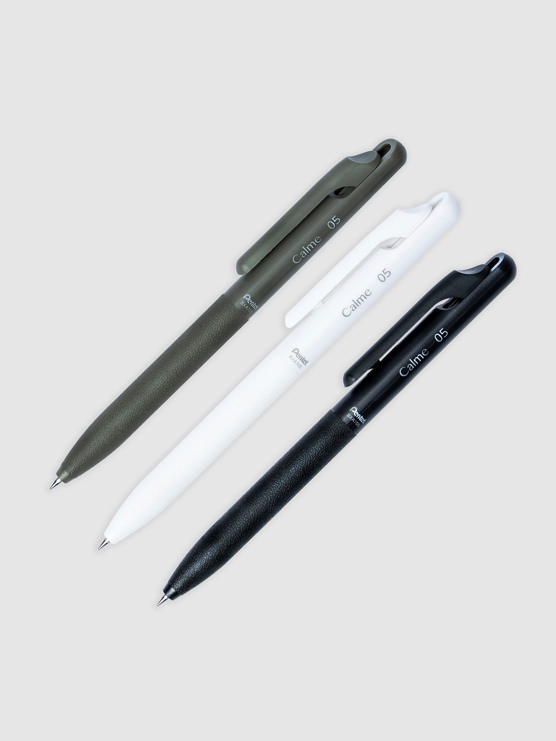 One of each color of the Pentel Calme Ballpoint Pen with a 0.5 mm nib resting perpendicular to each other, spaced evenly and angled to the right against a neutral background.