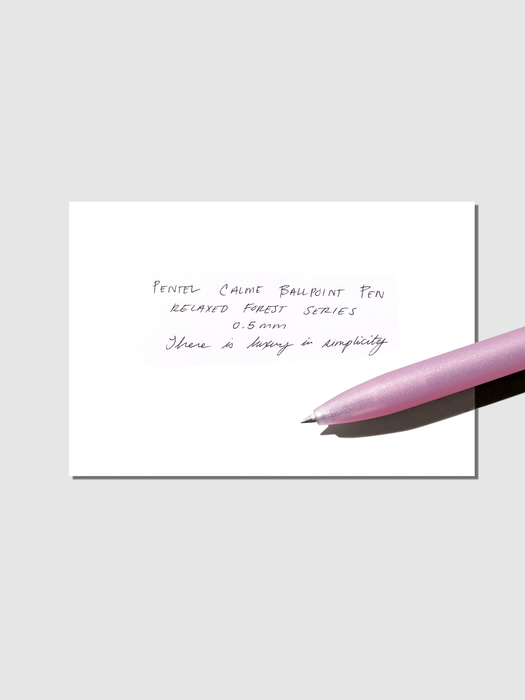 Pen test sheet shown with mauve pink pen on a neutral background.