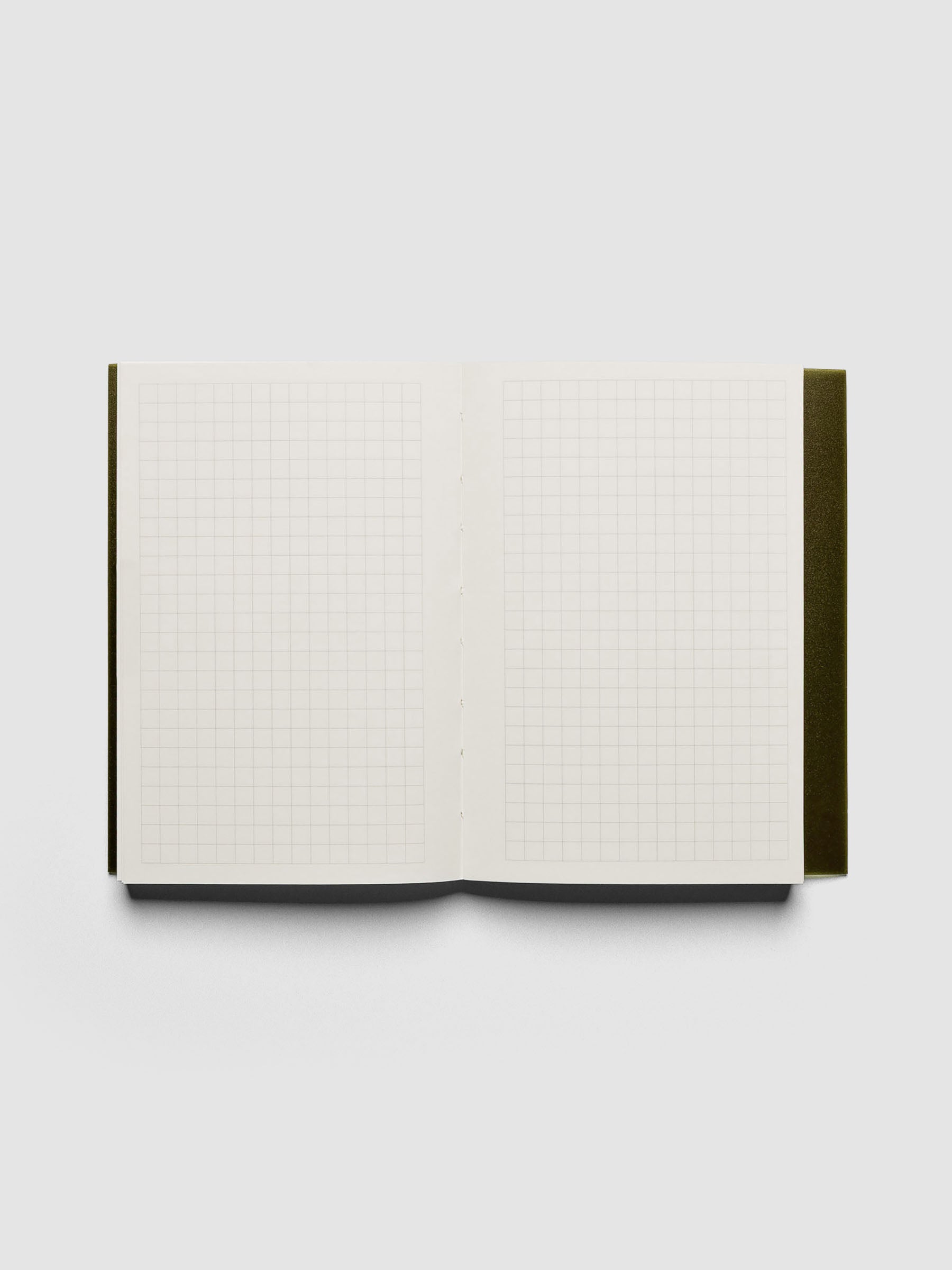 Perfect Bound Notebook | CP Petite | Graph | Olive shown laying flat, open, on a neutral background. Each page is in a graph layout.