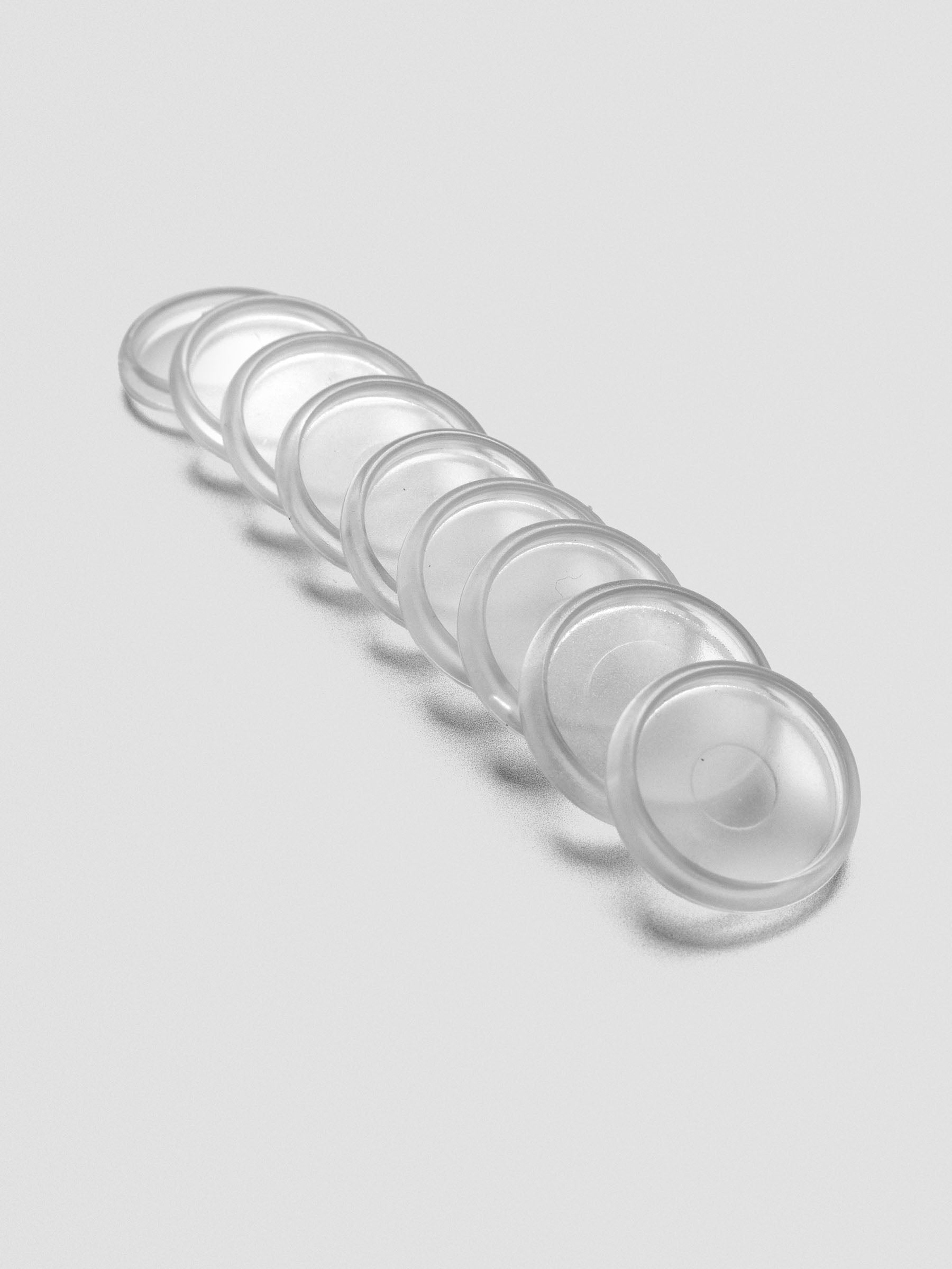 Set of nine Clear 0.75 inch planner discs angled and laid out on a neutral background.