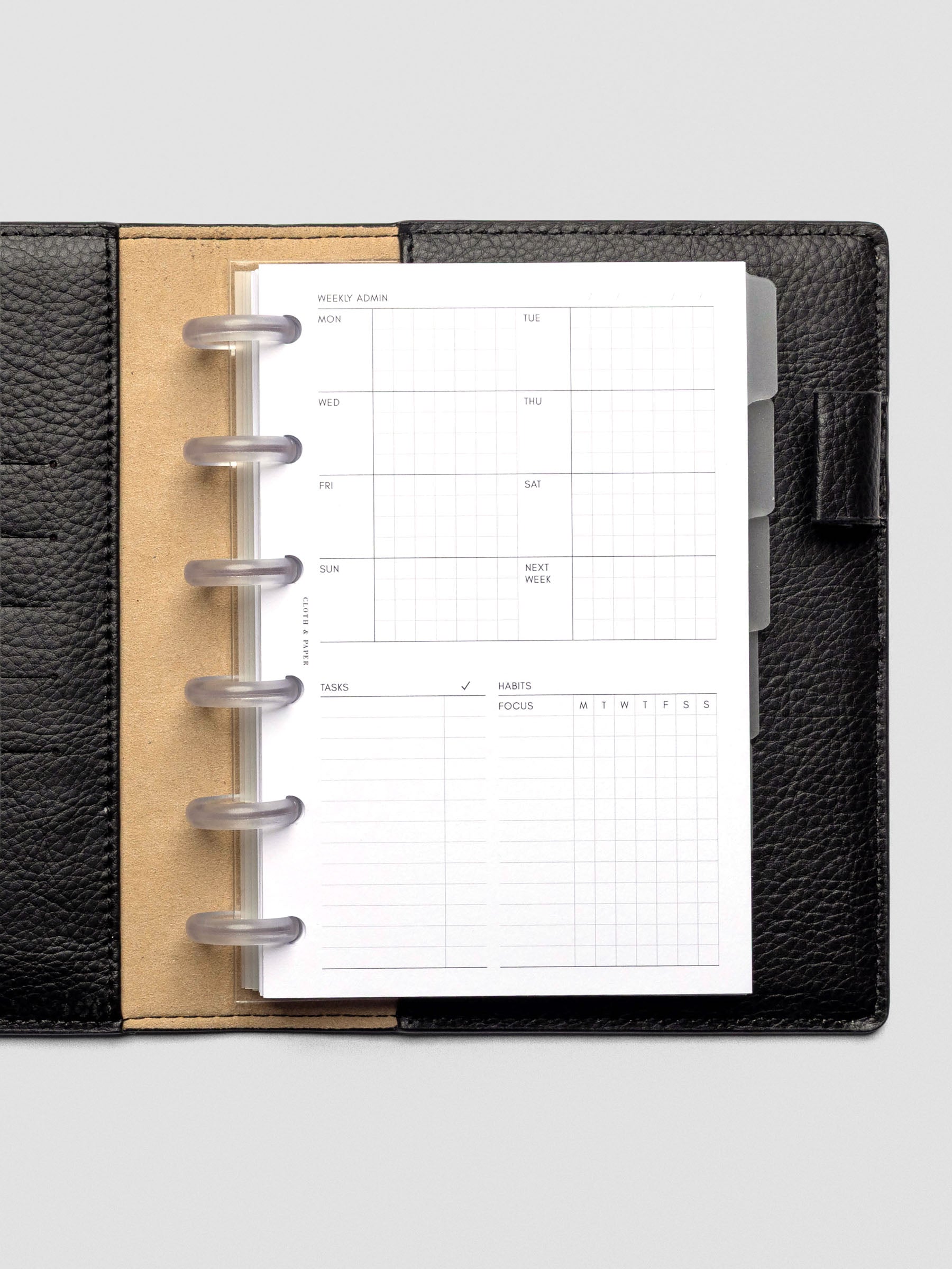 Six Clear 0.75 inch planner discs in use with CP Petite inserts and dividers in a leather folio.