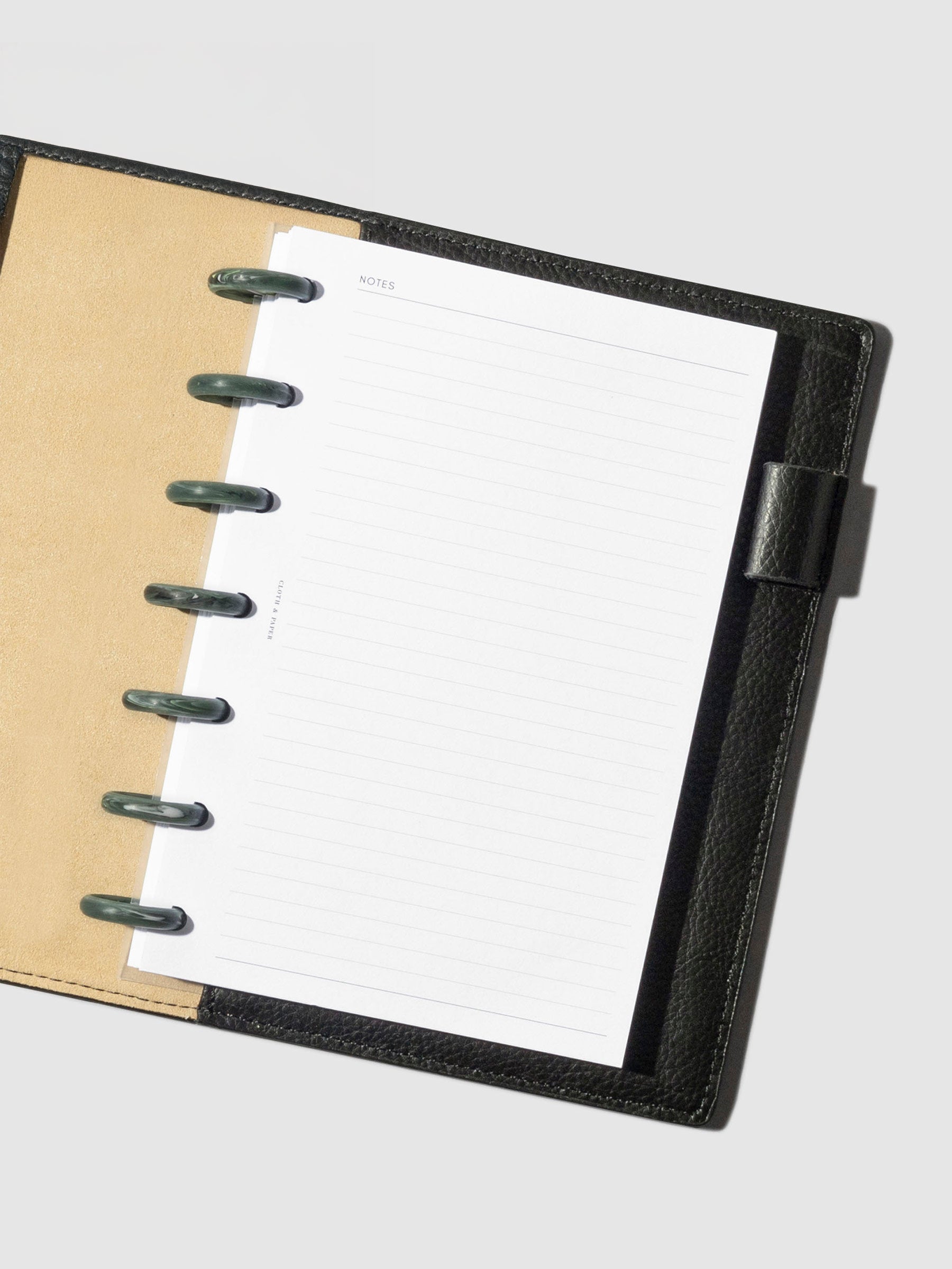 7 discs displayed inside a planner in a black leather folio.