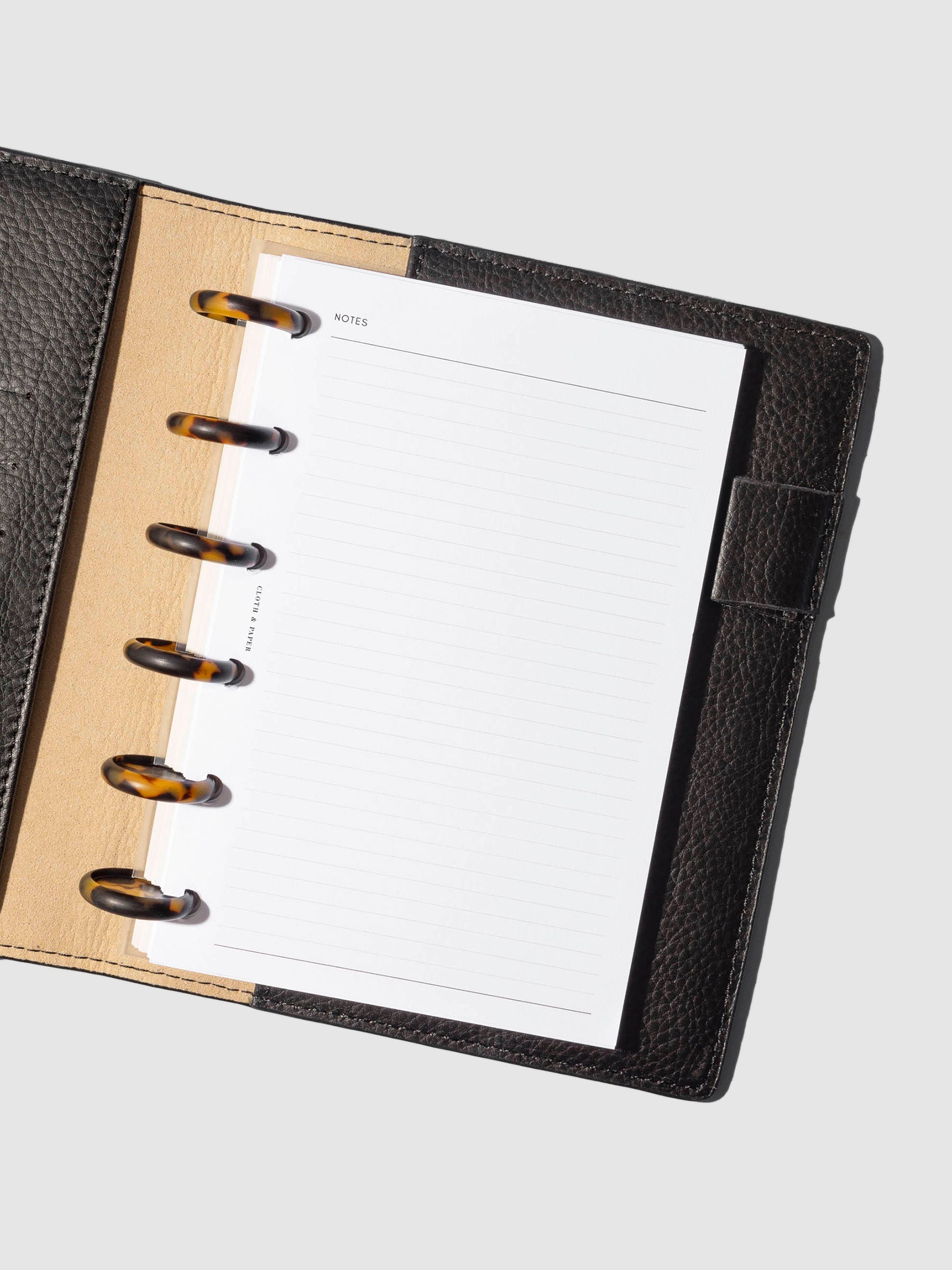 Discs in use inside a black leather agenda.