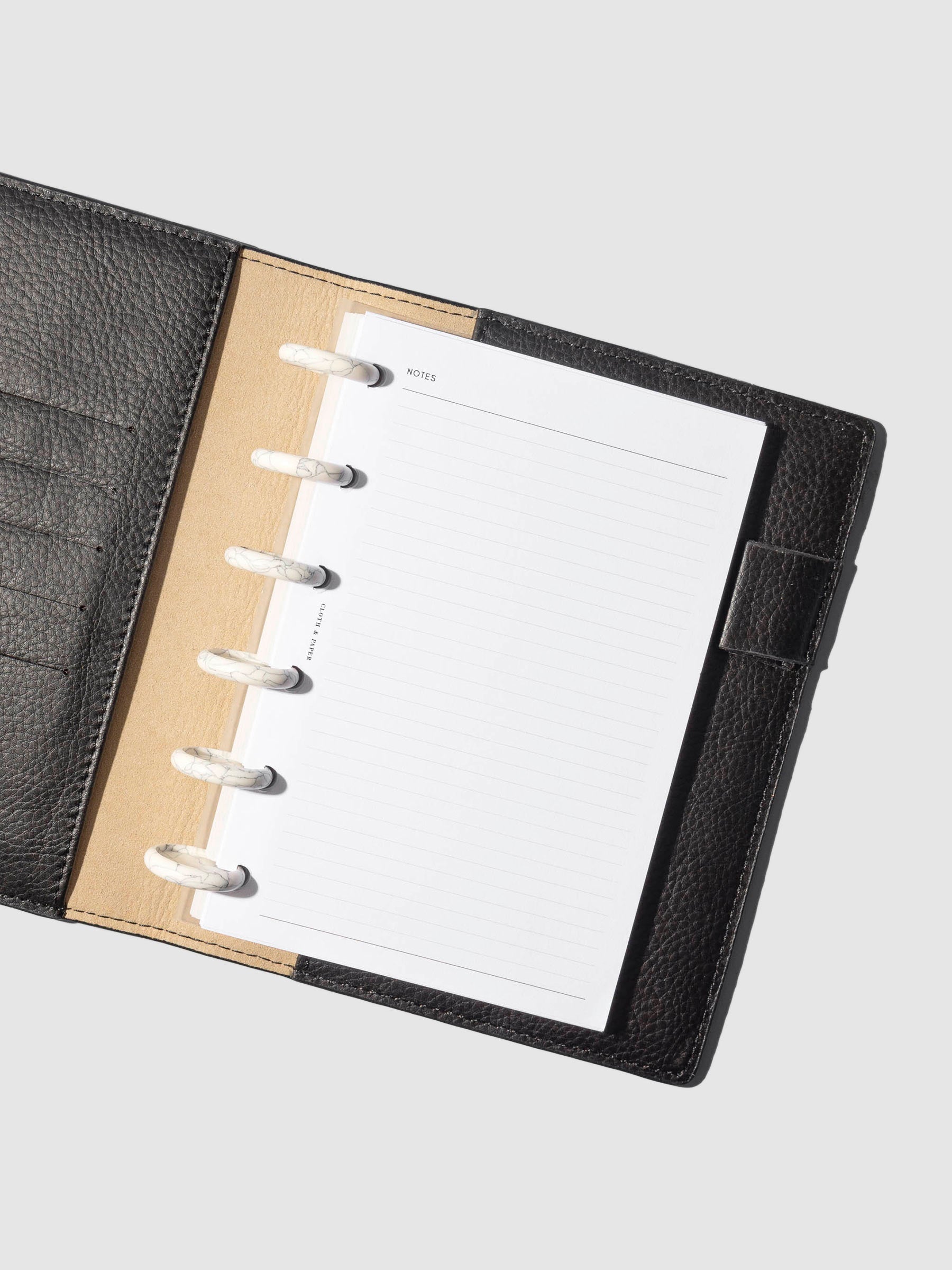 Discs in use inside a leather planner.