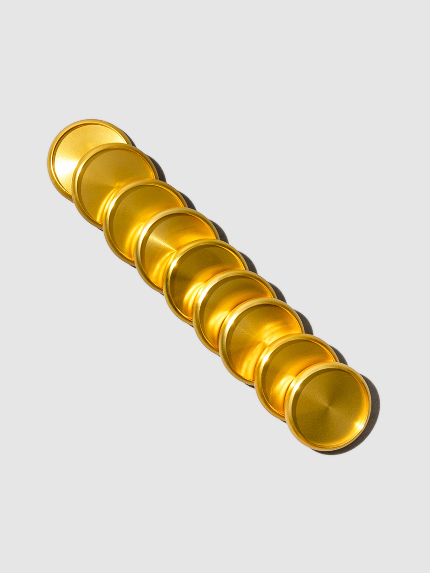 Planner Discs in Gold Aluminum with a 1.25 inch diameter stacked to the left against a neutral background.
