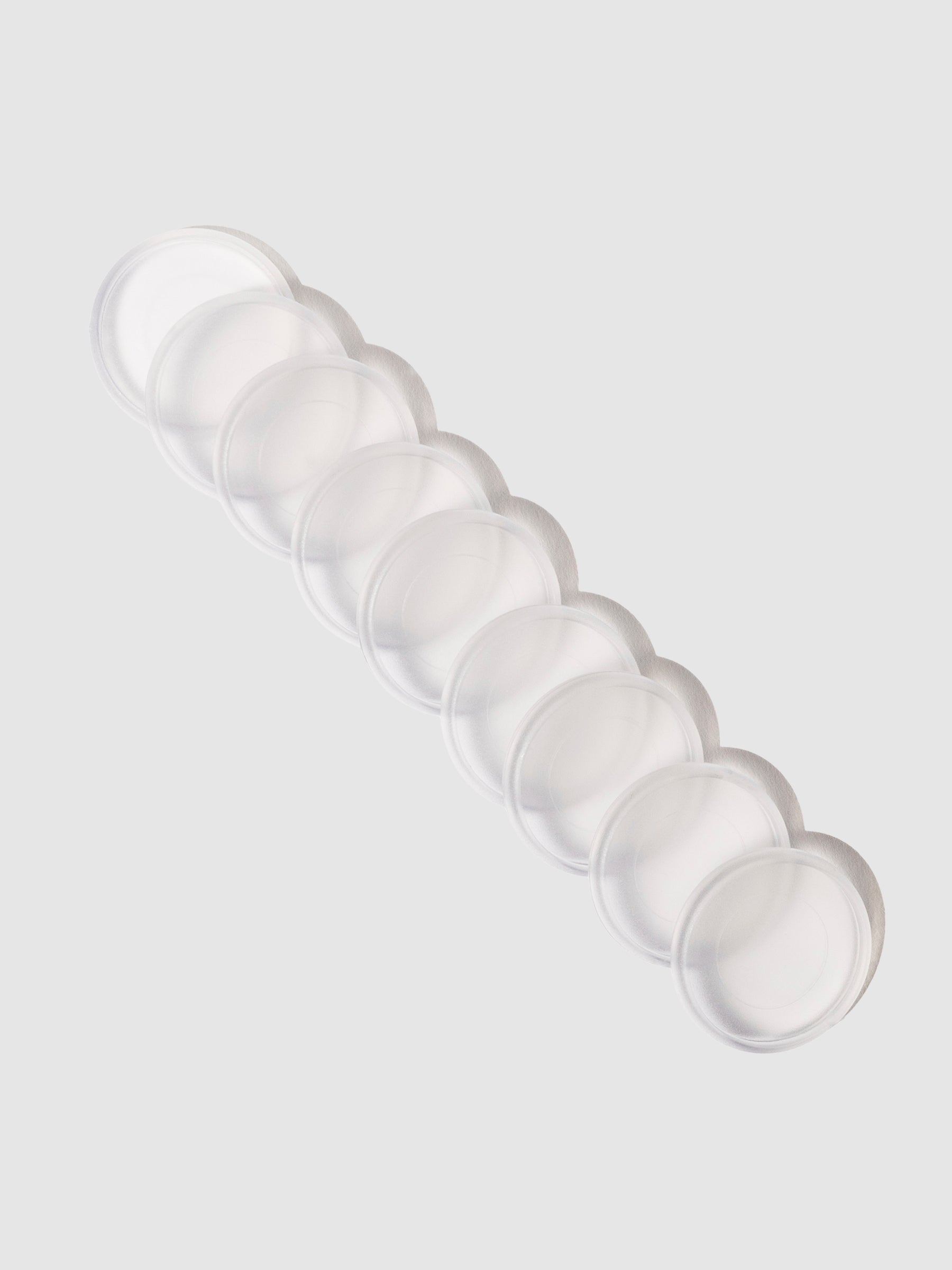 Planner Discs in Clear with a 1.25 inch diameter stacked to the left against a neutral background.