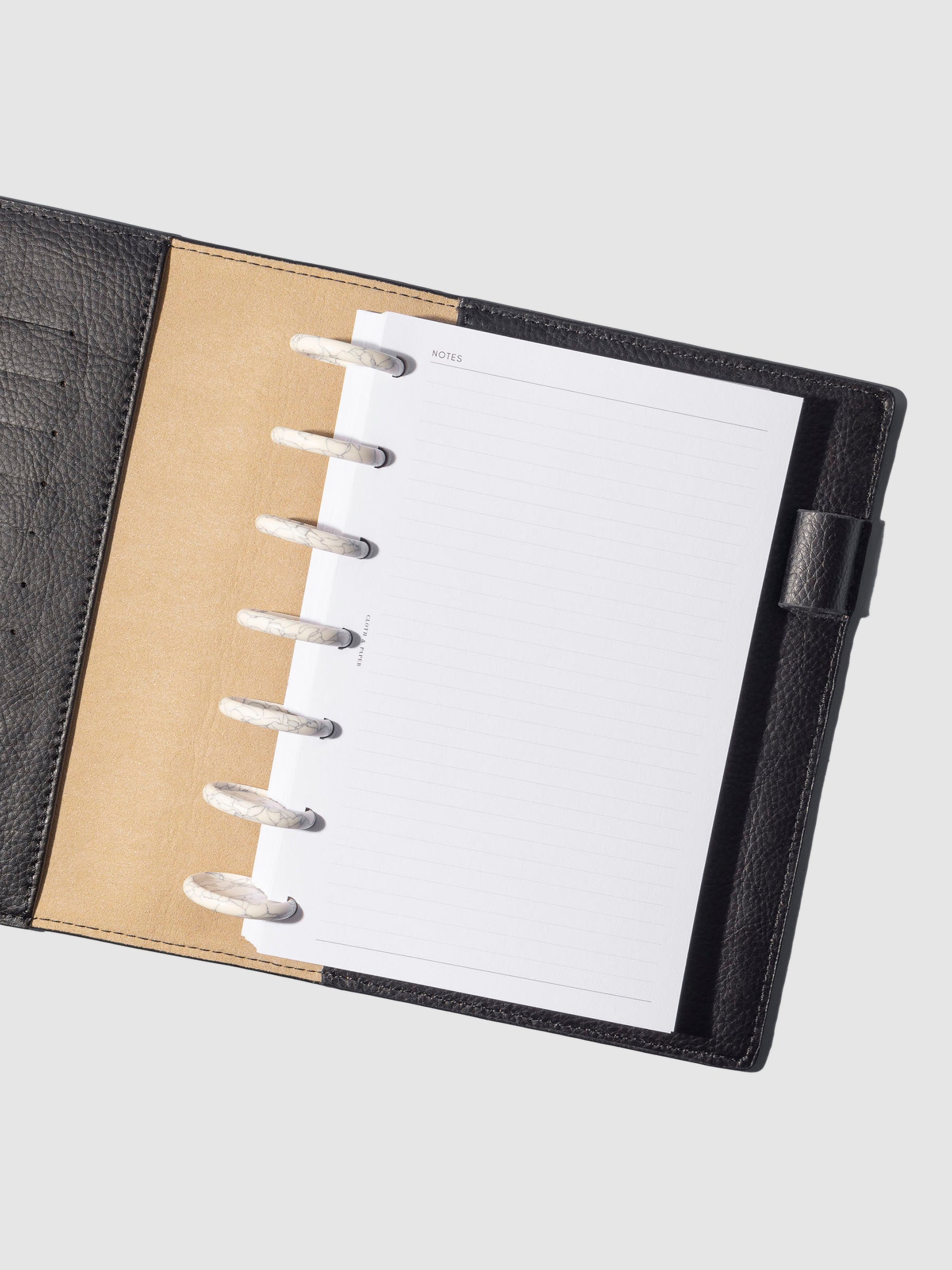 Discs displayed in use inside a leather agenda.