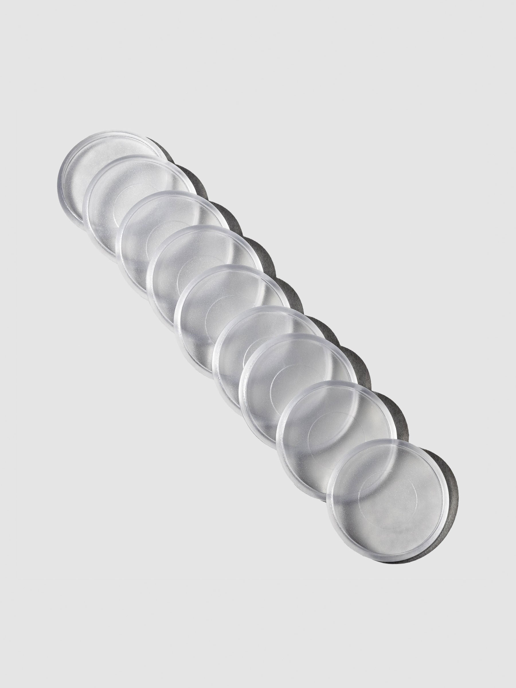 Clear plastic planner discs, 1.5 inch size, set of nine arranged in a row.