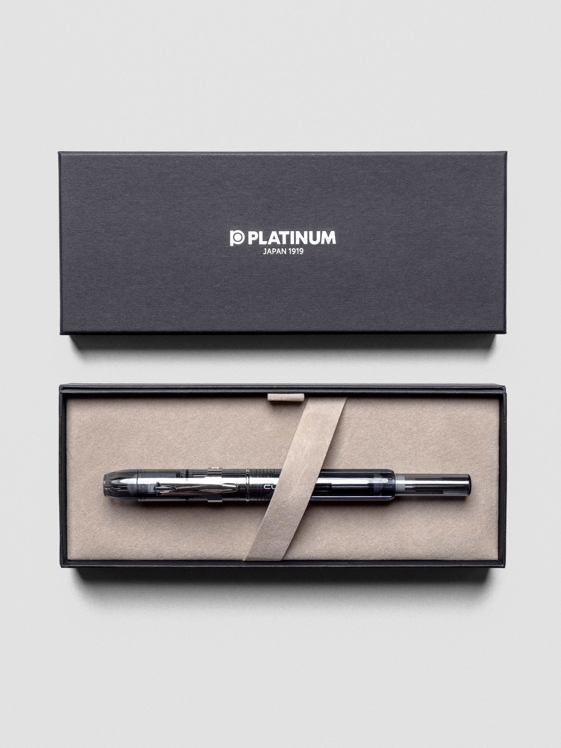 Close-up of Platinum Curidas Graphite Smoke Fountain Pen highlighting translucent barrel.