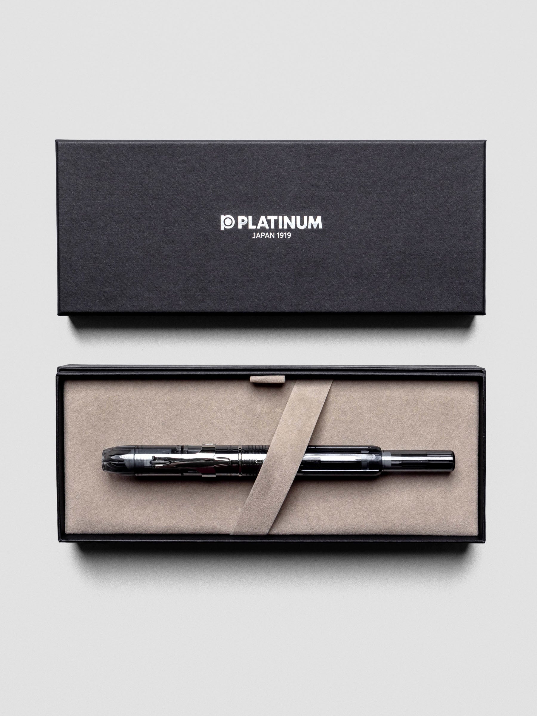 Close-up of Platinum Curidas Graphite Smoke Fountain Pen highlighting translucent barrel.