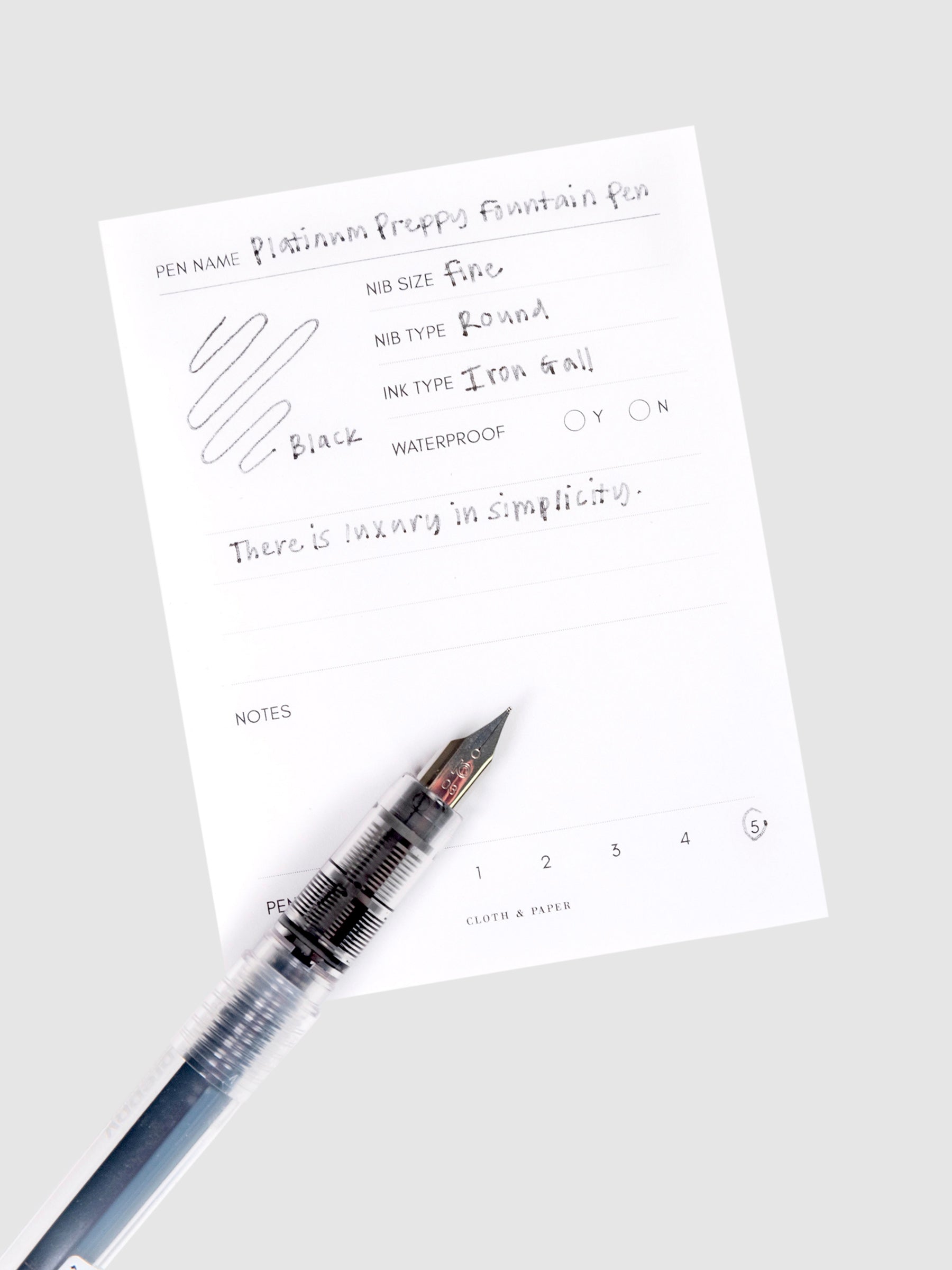 Platinum Preppy Fountain Pen, Crystal, Cloth and Paper. Pen resting on pen test sheet displaying writing sample.