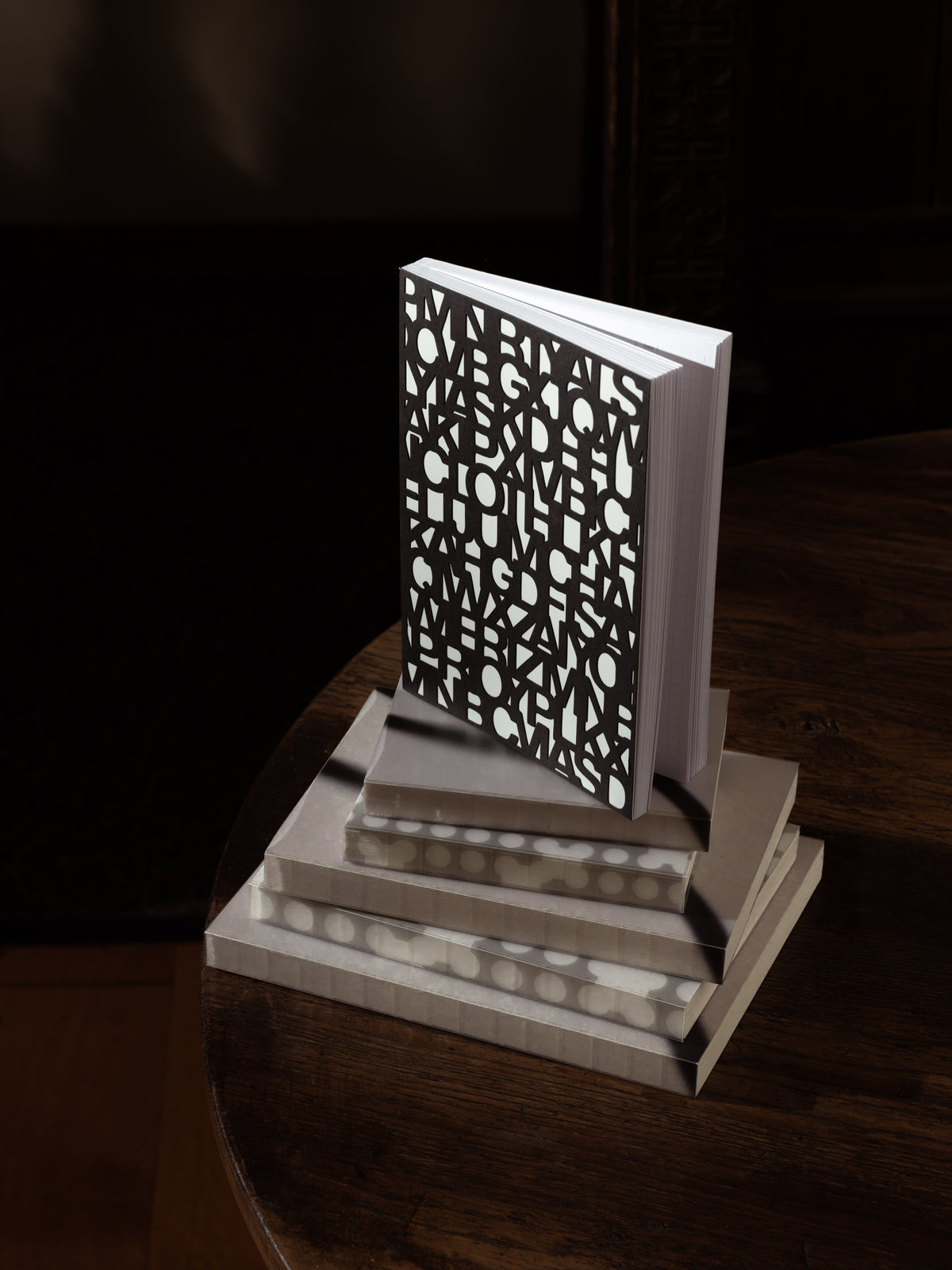 The Precision Notebook | A5 closed, showing the cover cut all the way through in the Precision letter pattern over a light layer beneath
