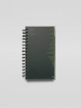 A spiral-bound Recipe Book System with a dark green matte cover featuring minimal lime green text design on the front.