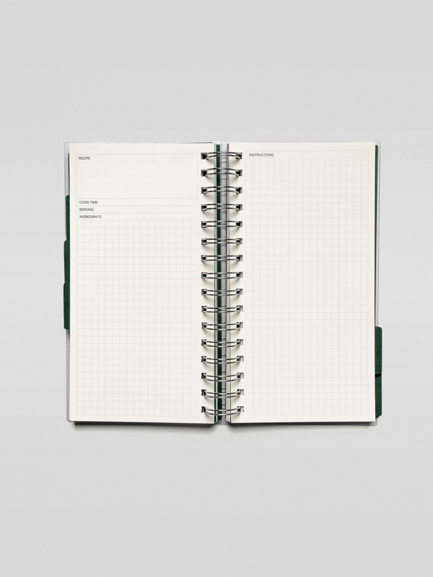 Open spread of the Recipe Book System featuring a grid layout for recording recipes, including sections for cook time, serving, and ingredients.