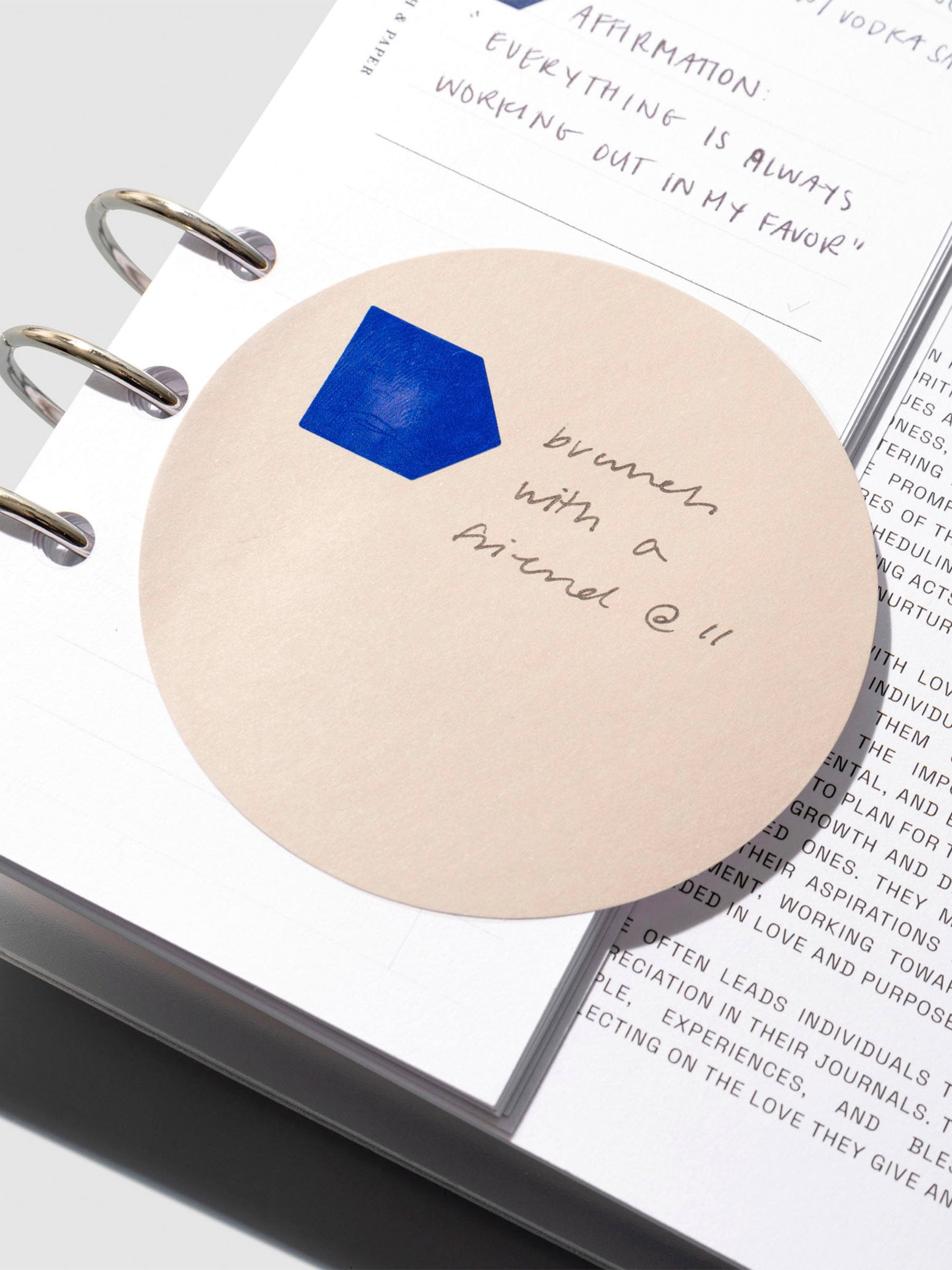 Sticky note displayed inside a leather planner.