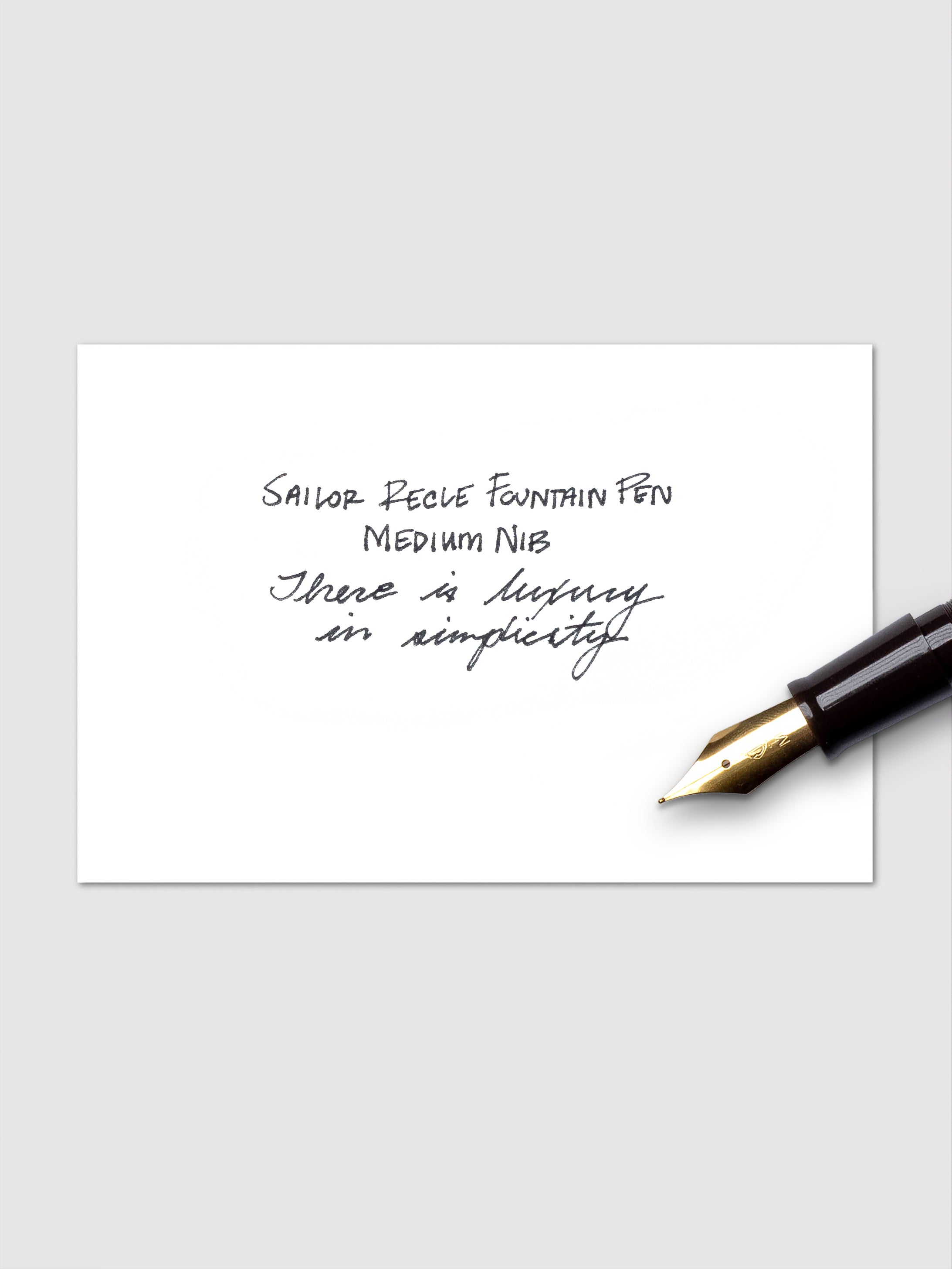 Handwritten example of black ink cartridge pictured with the nib of a fountain pen.