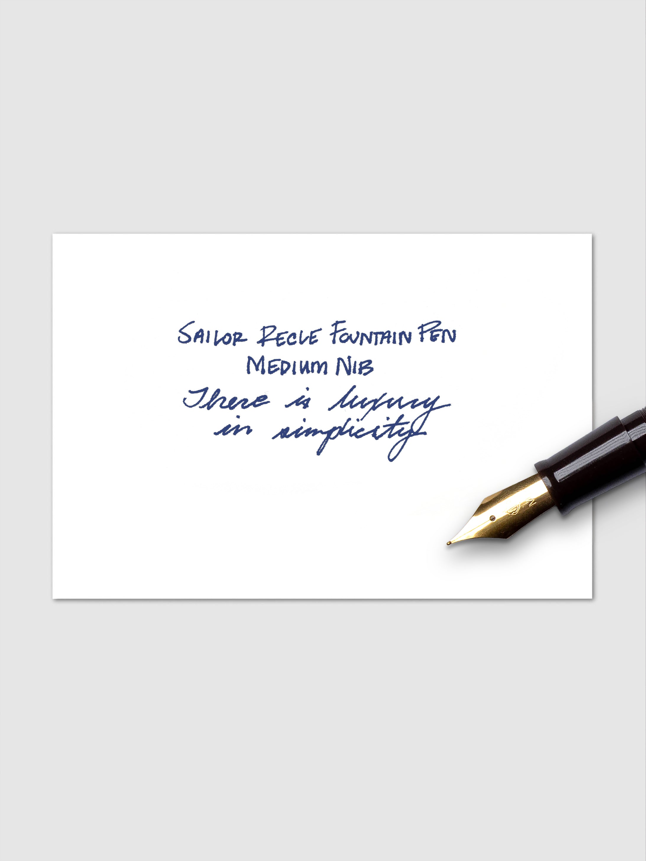Handwritten example of blue ink cartridge pictured with the nib of a fountain pen.
