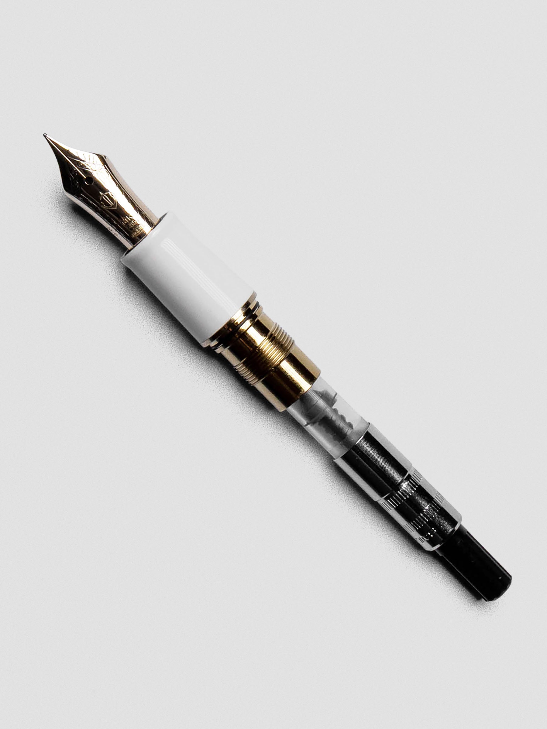 Sailor Mini Ink Converter displayed at an angle to show screw-style filling system.