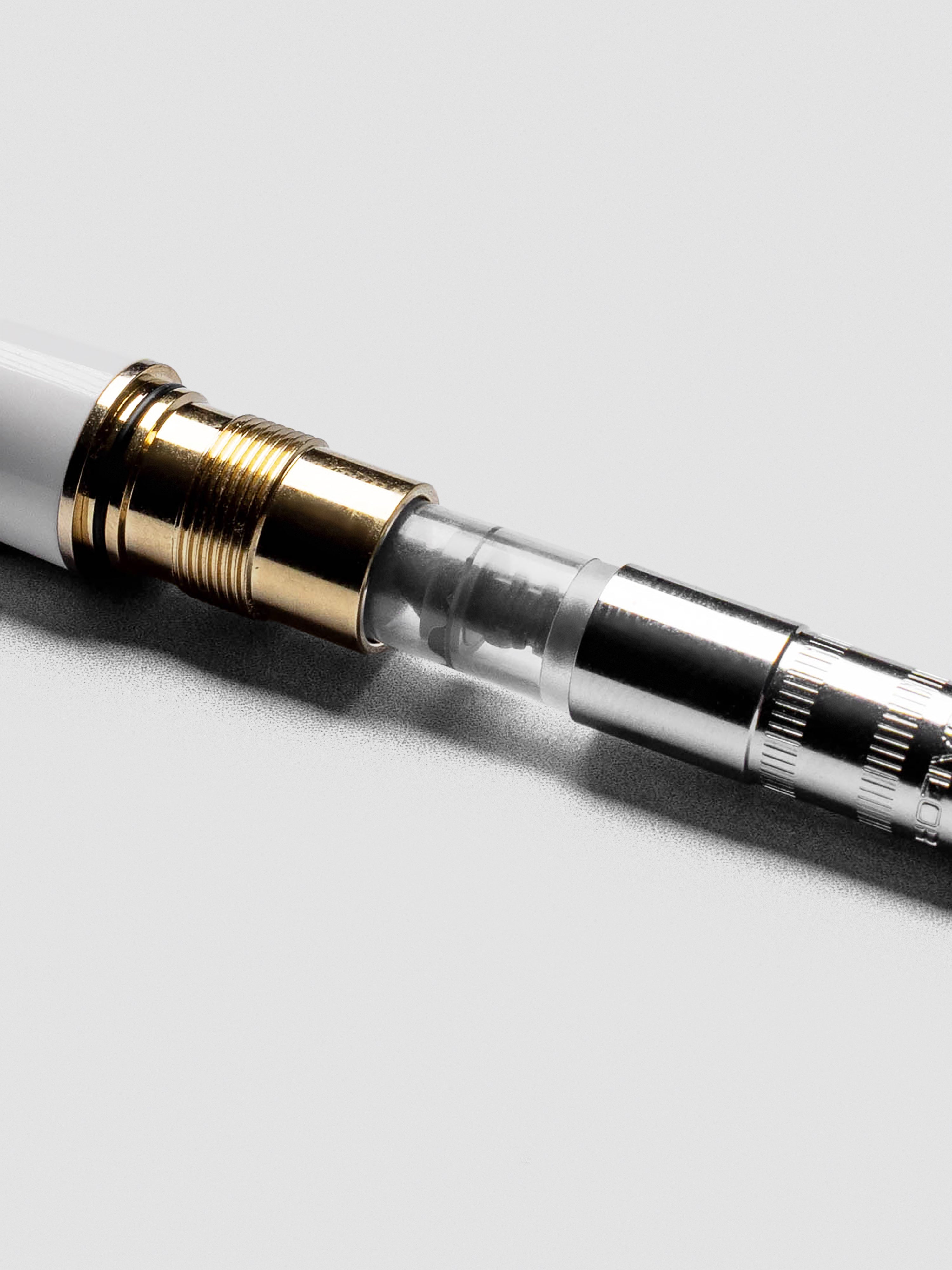 Close view of Sailor Mini Ink Converter highlighting transparent body and piston detail.