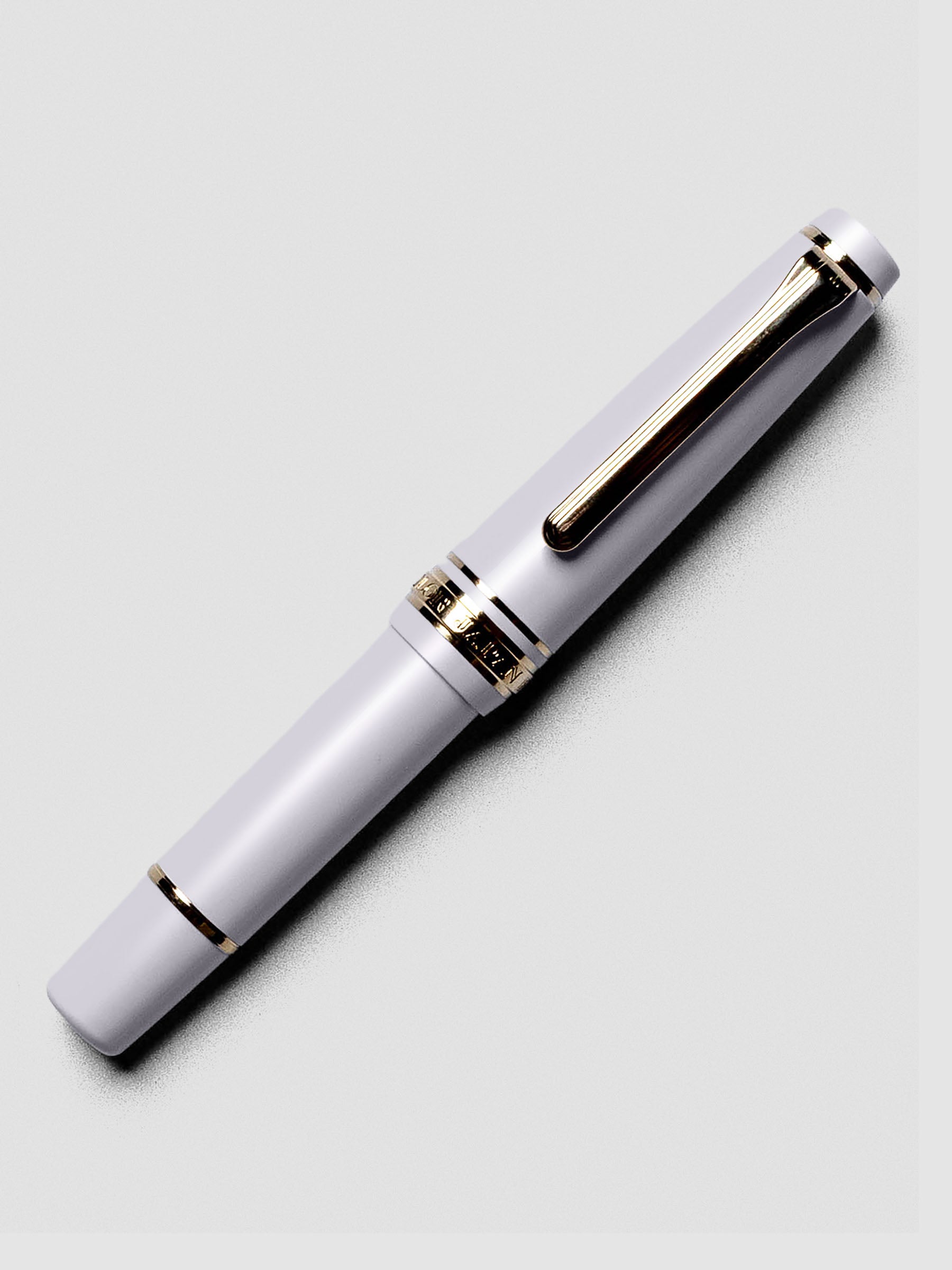 Uncapped Sailor Pro Gear Slim Mini Fountain Pen in Ayur Gray with nib exposed.