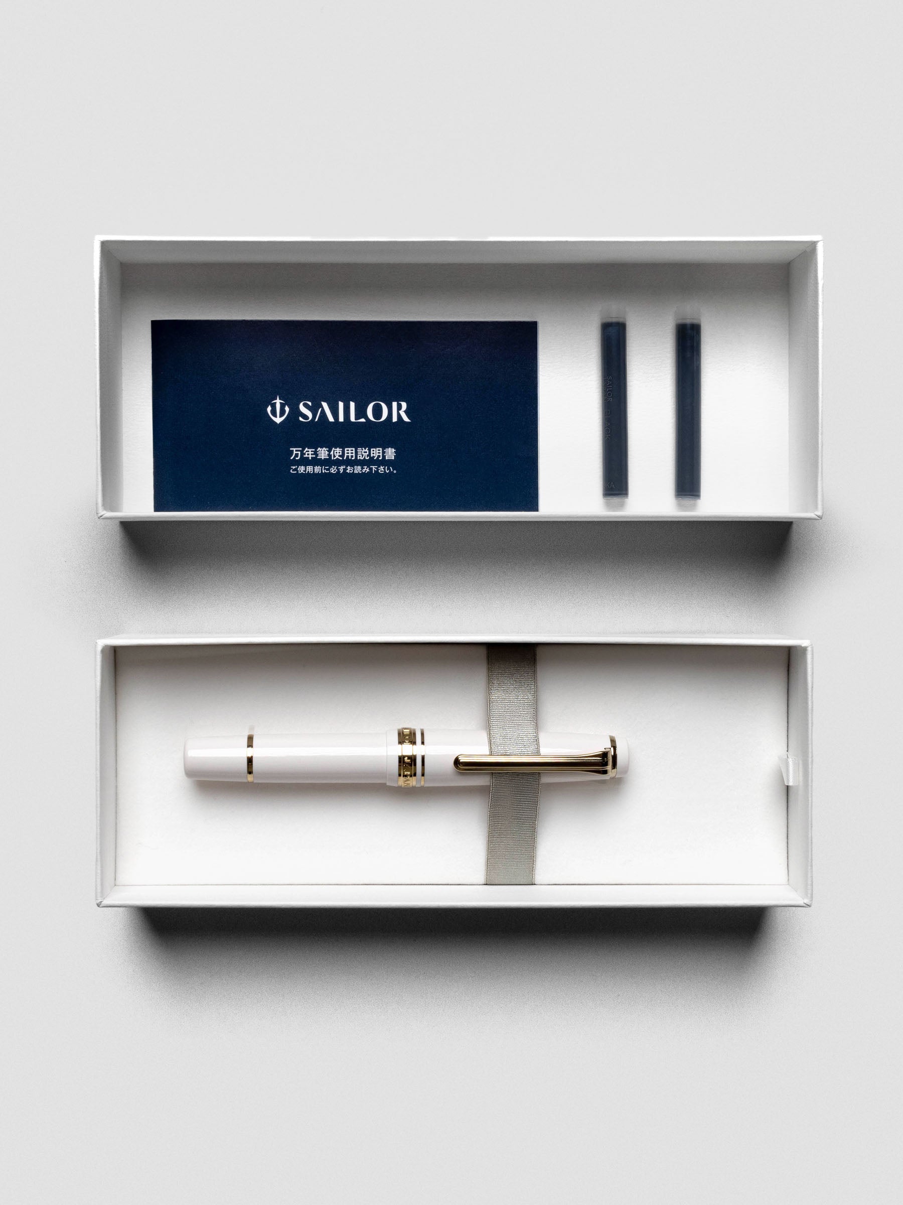 Sailor Pro Gear Slim Mini Fountain Pen in Beni White, shown capped on display.