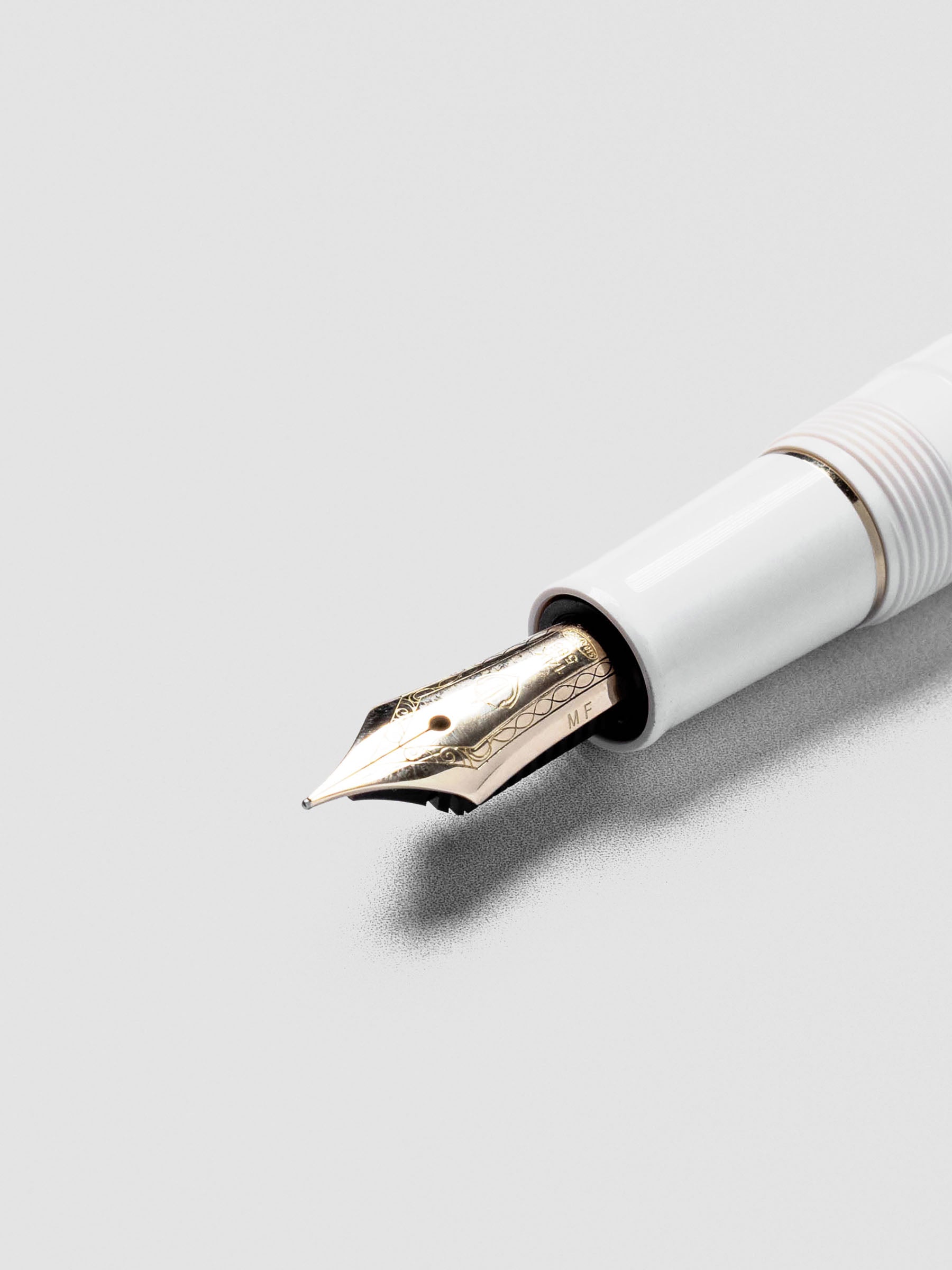 Close-up of Sailor Pro Gear Slim Mini Fountain Pen nib with Beni White barrel.