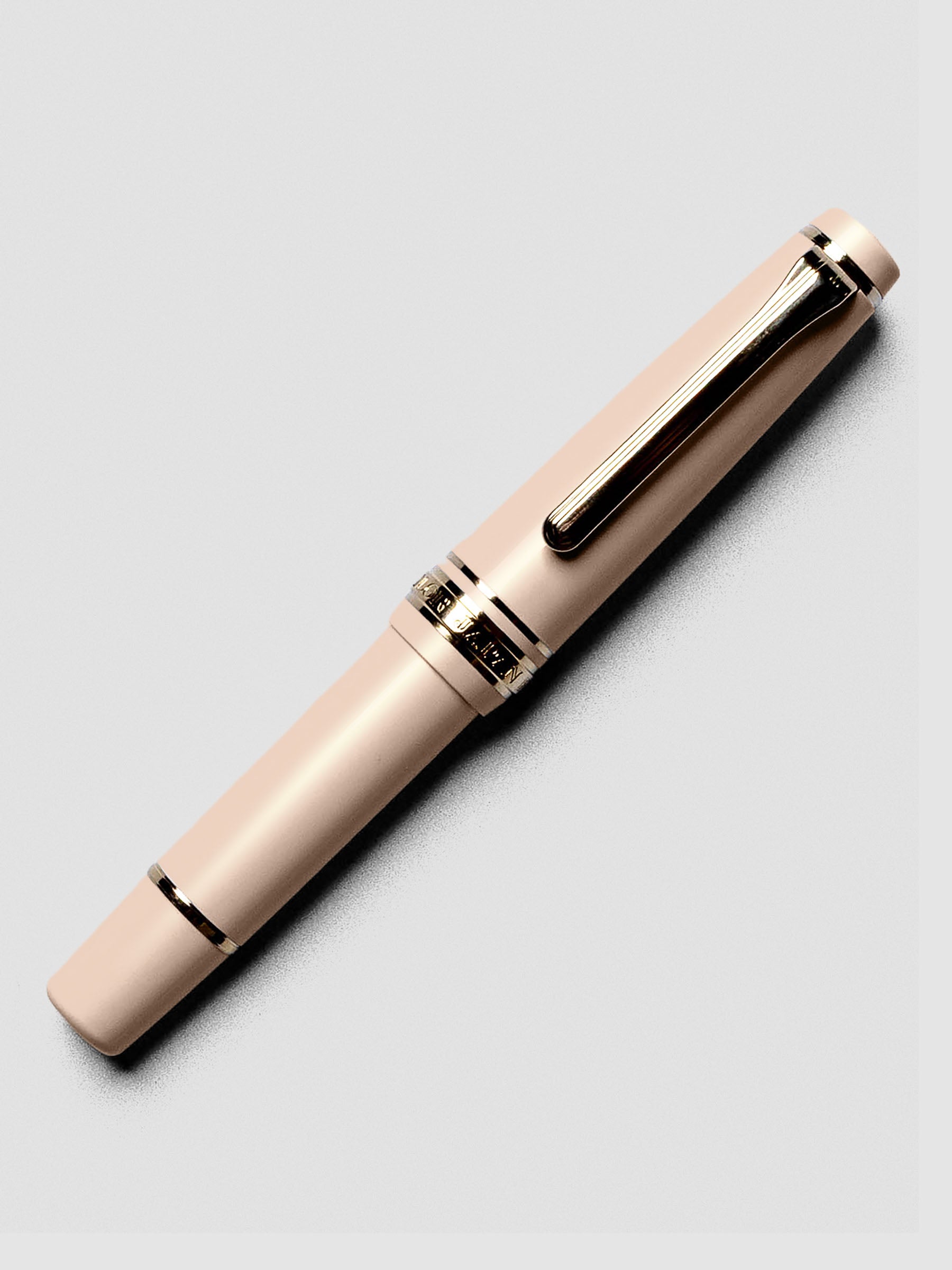 Uncapped Sailor Pro Gear Slim Mini Fountain Pen in Zween Pink with nib exposed.