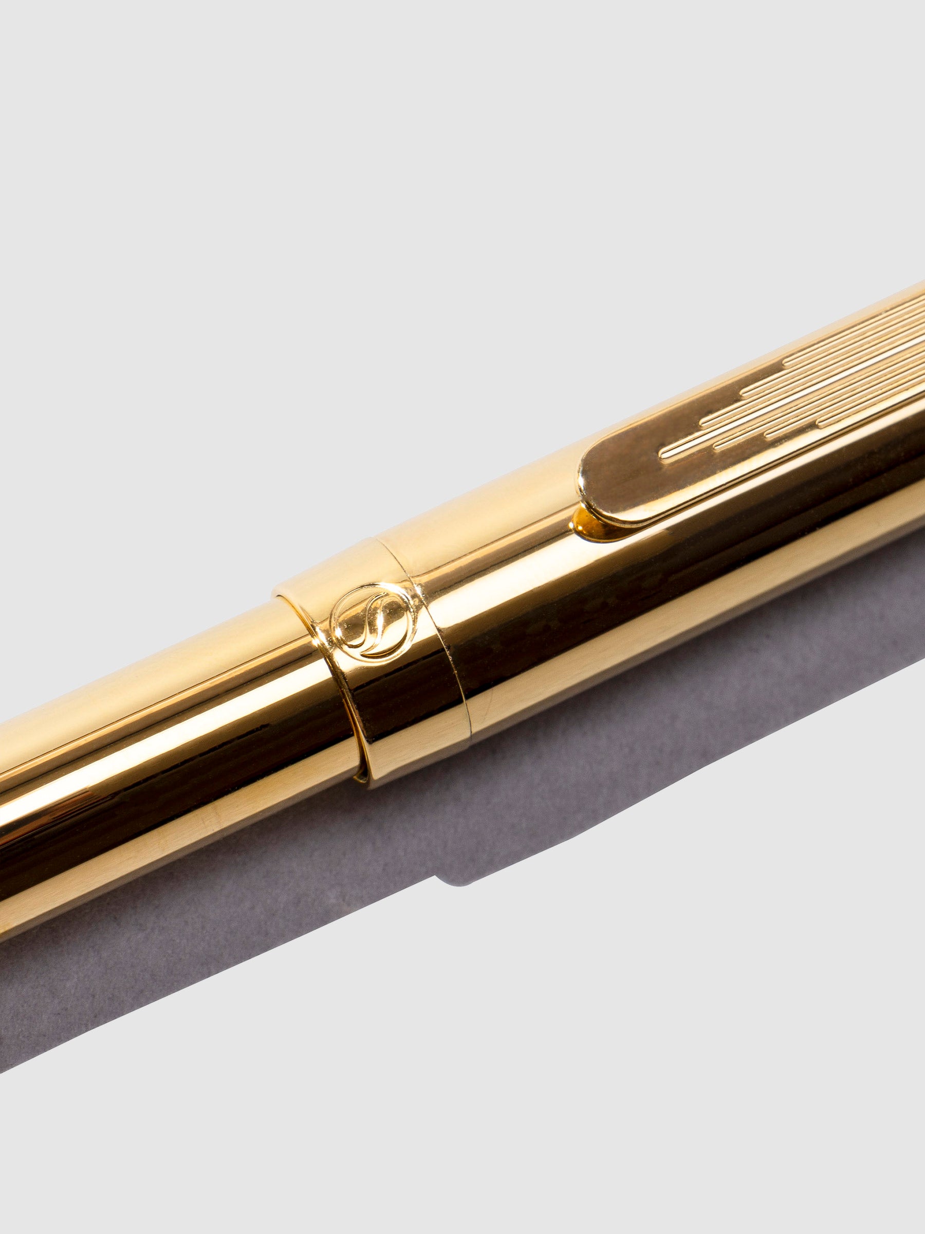 Closeup of pen showcasing a Scriveiner emblem.